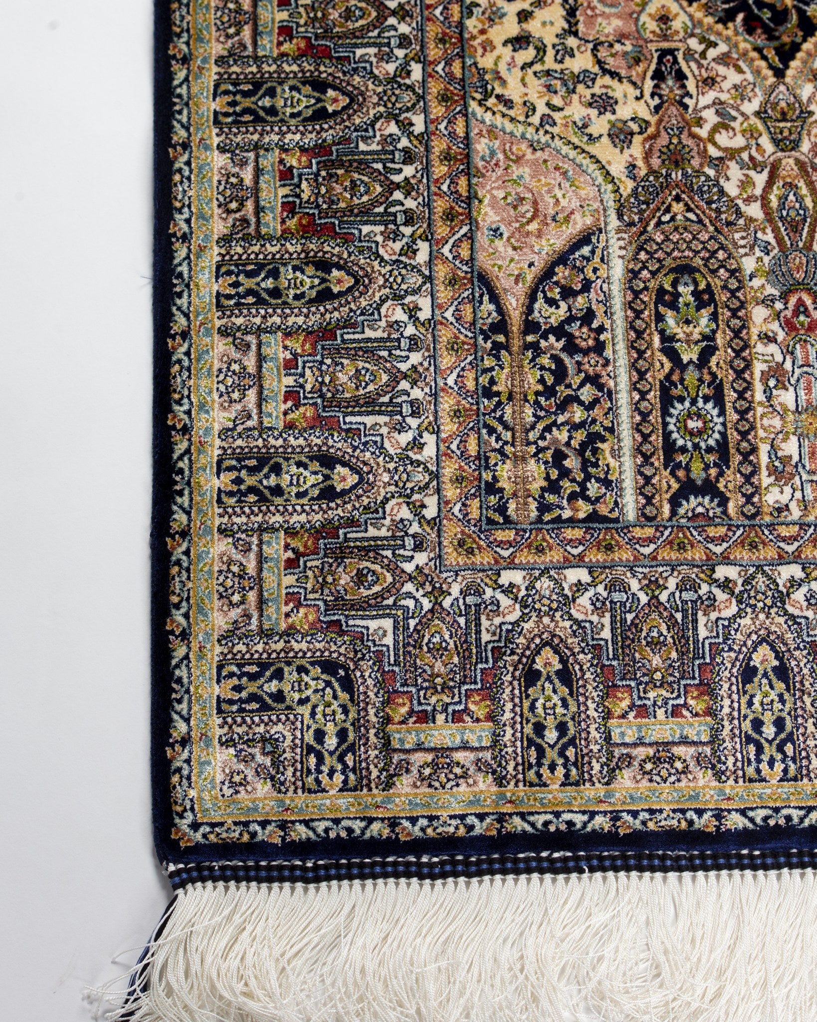 Corner and border of the Anahita beige silk rug with silk fringe