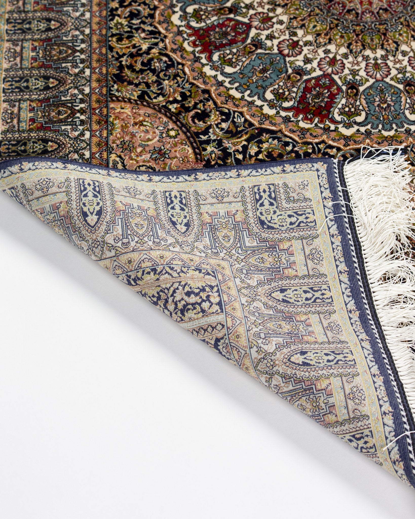 Corner detail of the Anahita silk rug showing the woven back