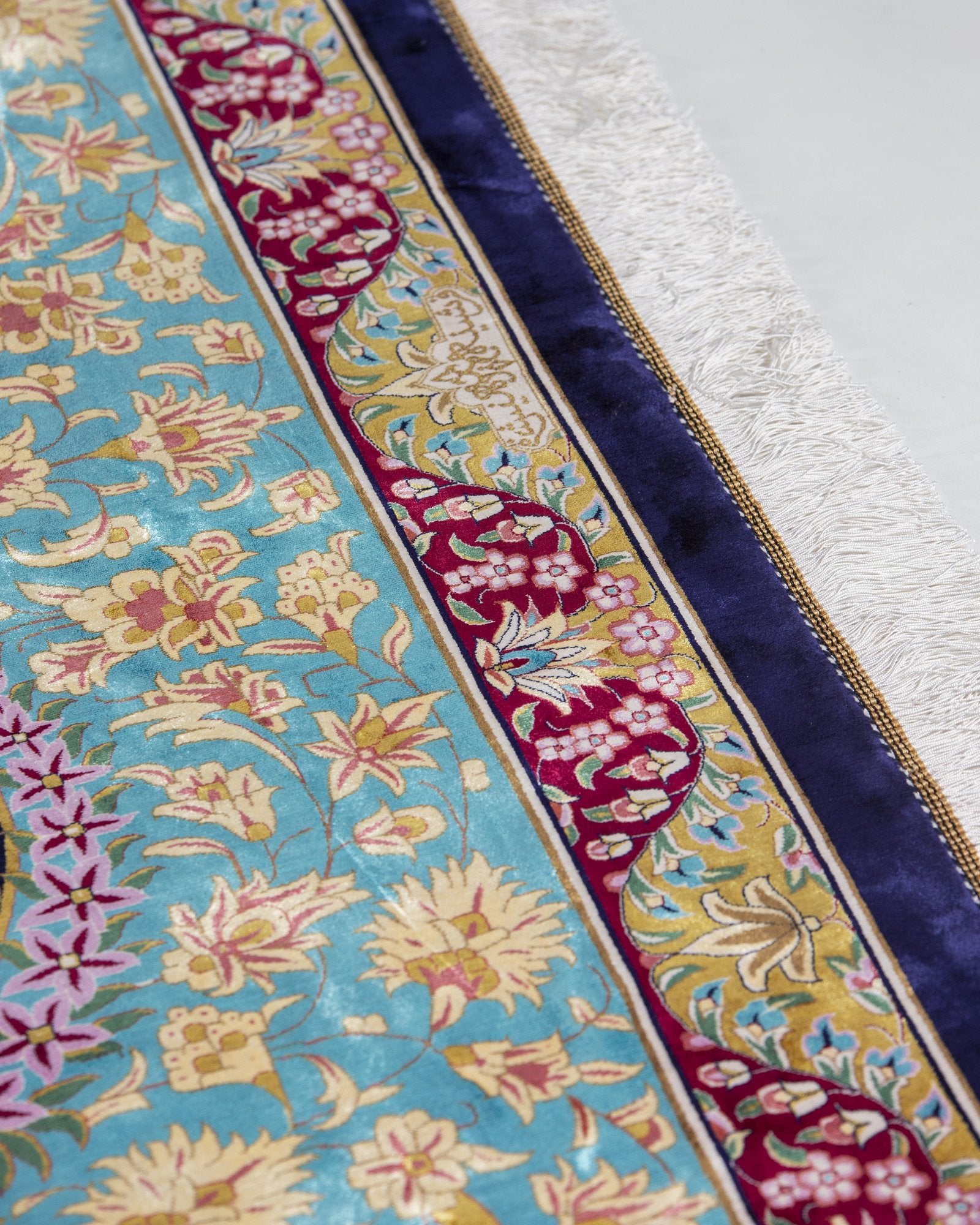 Ariana silk carpet angled view showing turquoise and navy tones, 300 x 400 cm - Tabeer Homes Dubai