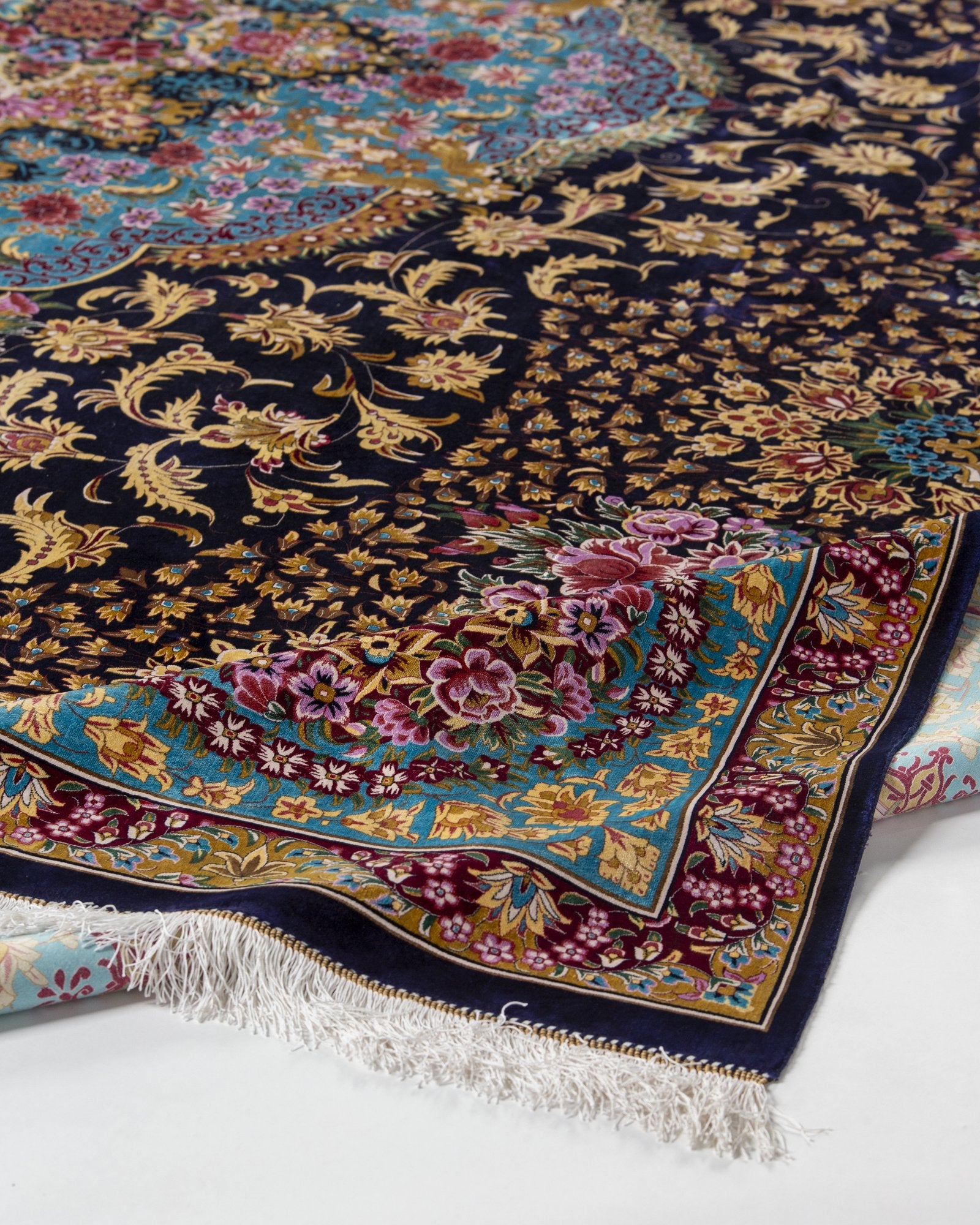 Ariana Persian silk rug folded corner showing fine weave, turquoise and navy 300 x 400 cm - Tabeer Homes Dubai
