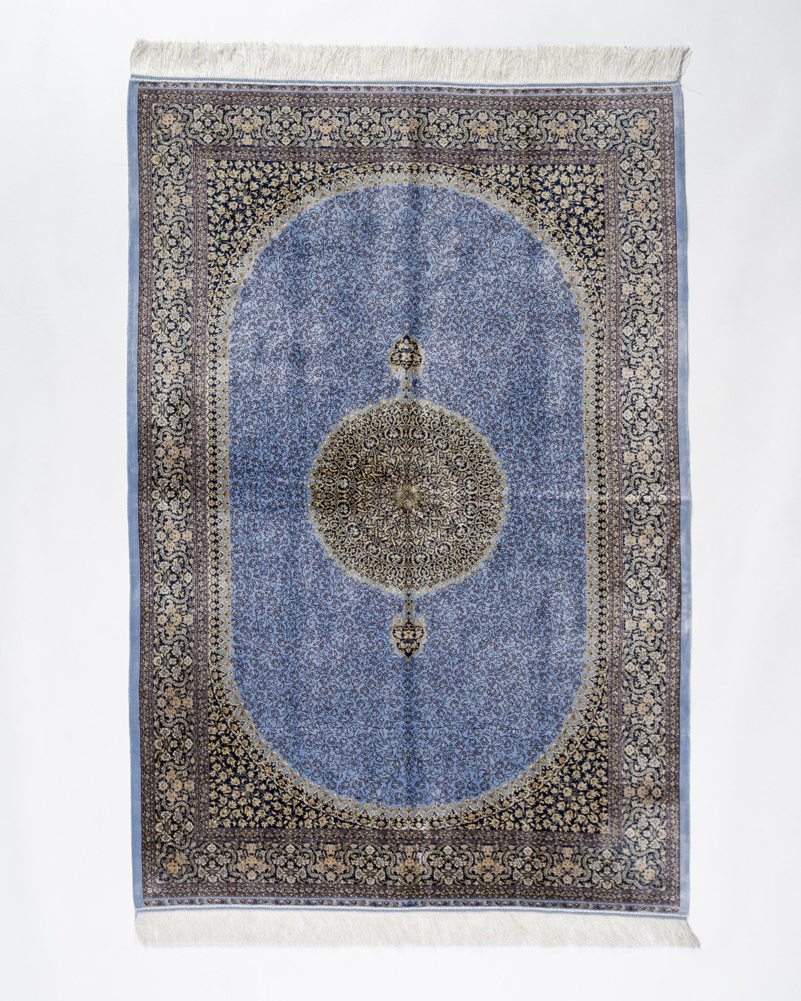 Aseman blue silk rug 150 x 100 cms with a central medallion on a sky blue field