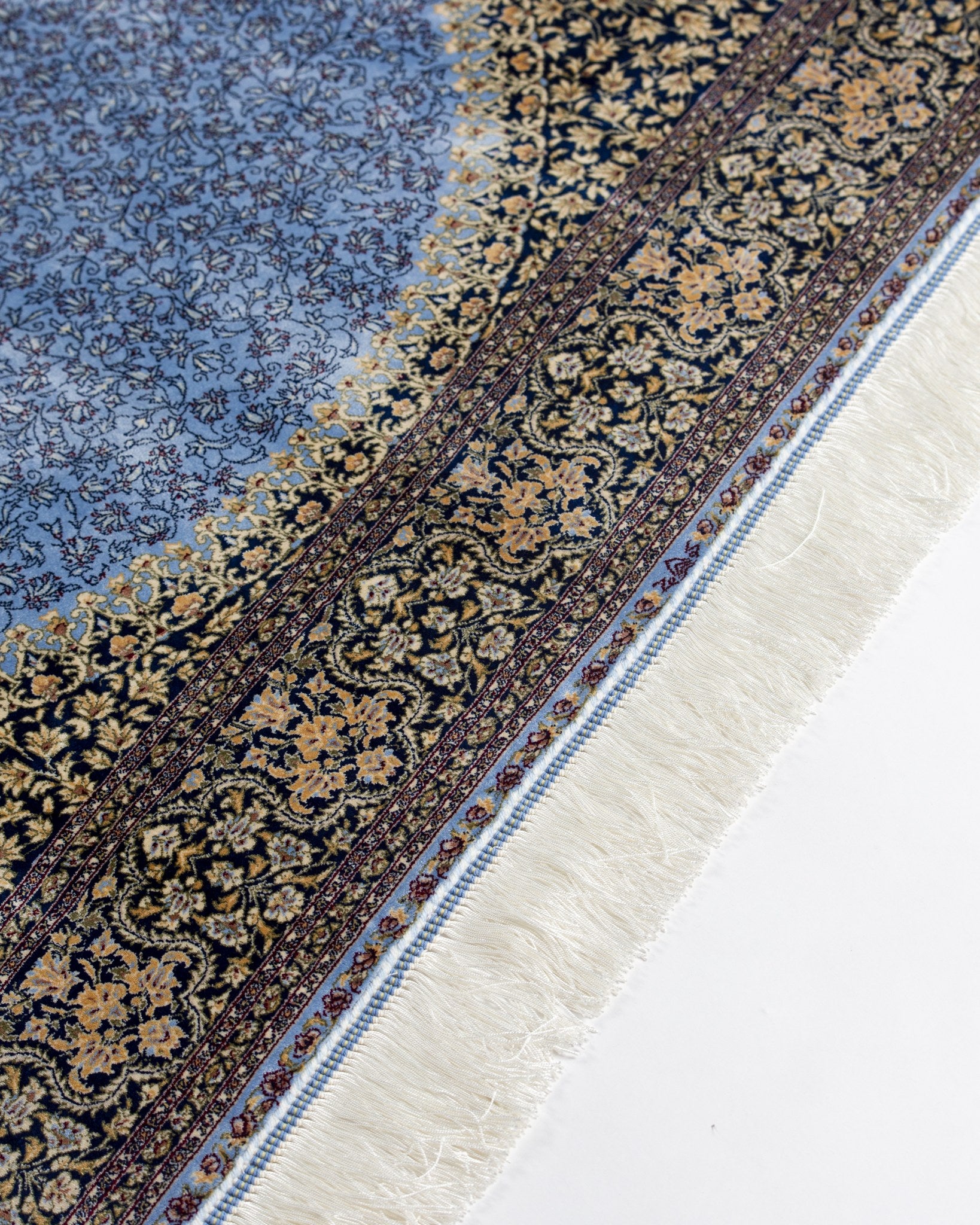 Border pattern of the Aseman silk rug with fringe