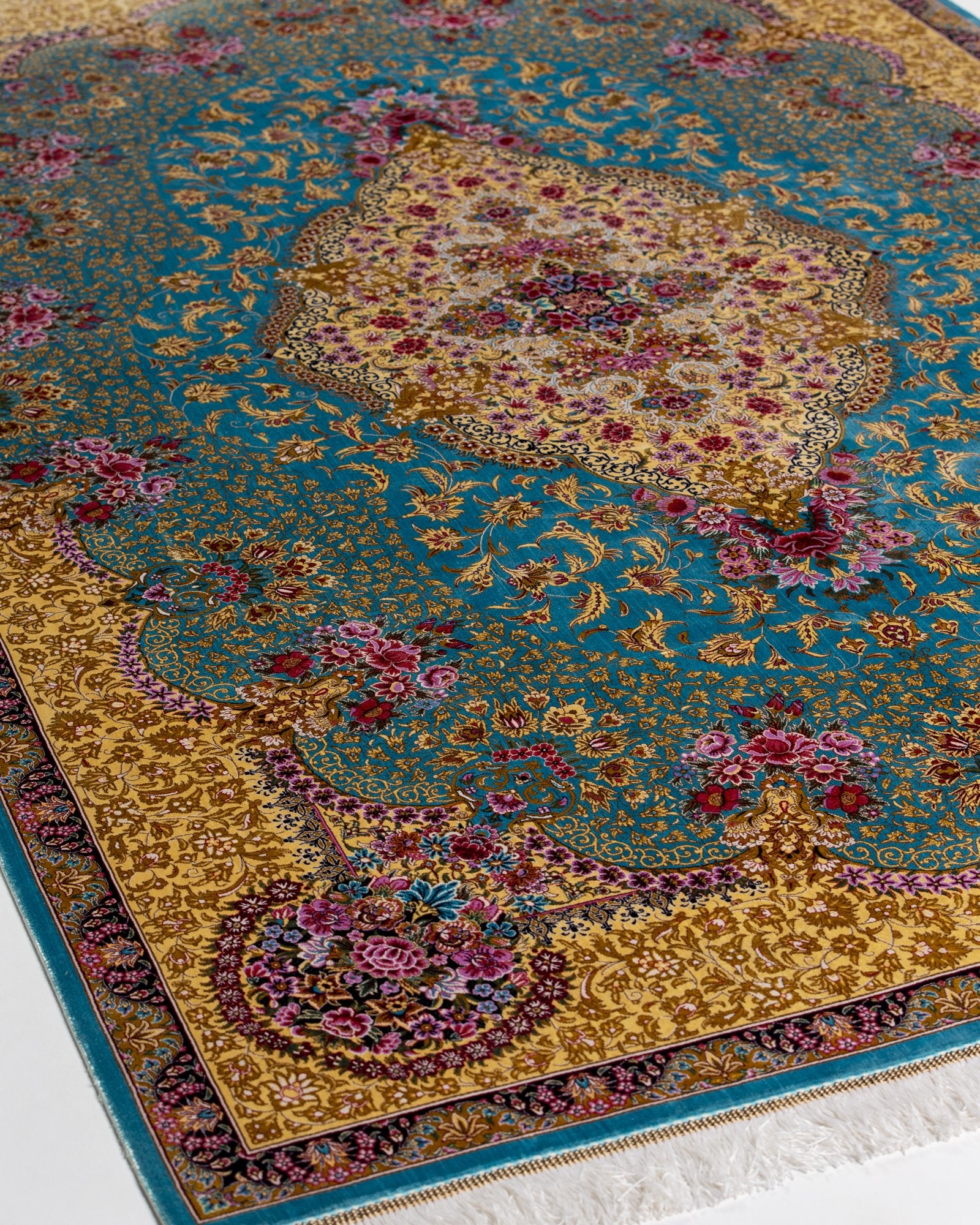 close view of the medallion on the Aurelia teal silk rug