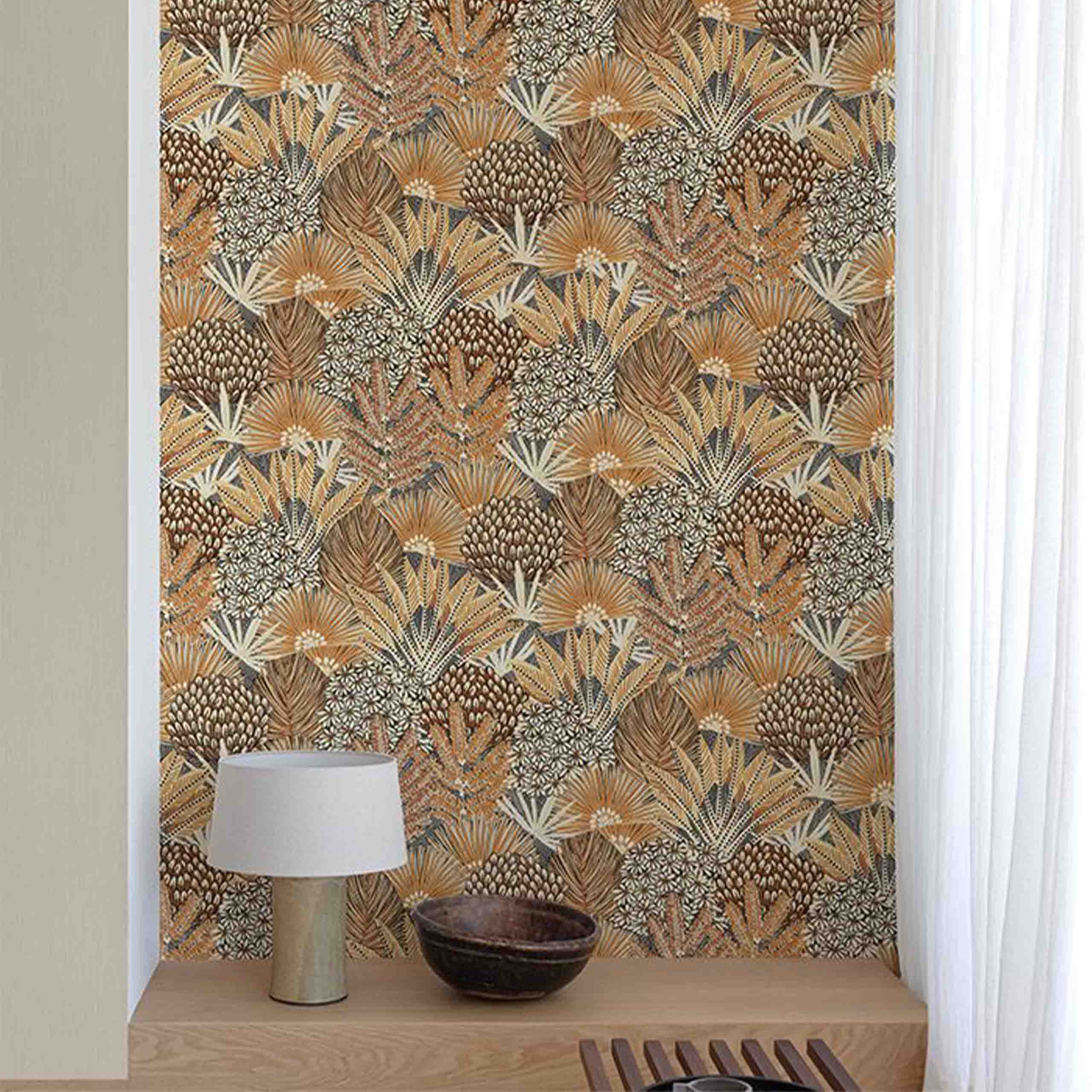 Aurelia wallpaper displayed in a cozy room, showcasing vibrant floral and botanical patterns in warm brown and orange hues.