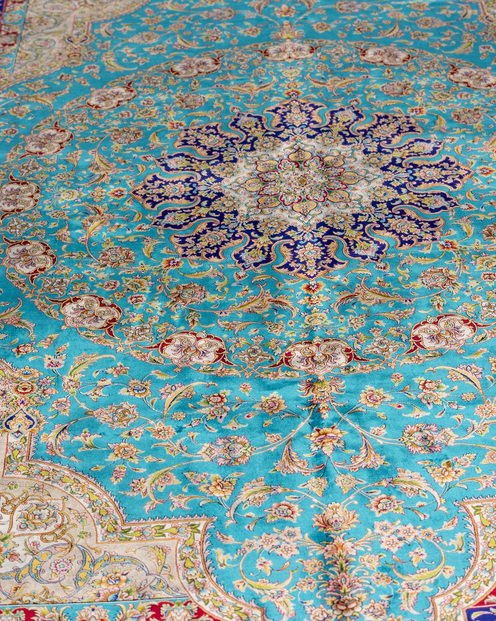 close view of the central medallion on the Marina turquoise silk rug