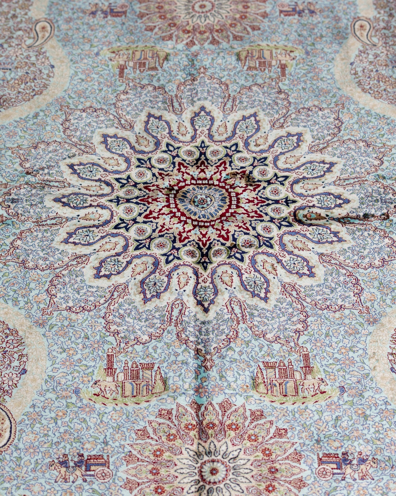 Close view of the Banafsheh silk rug star medallion in teal and plum