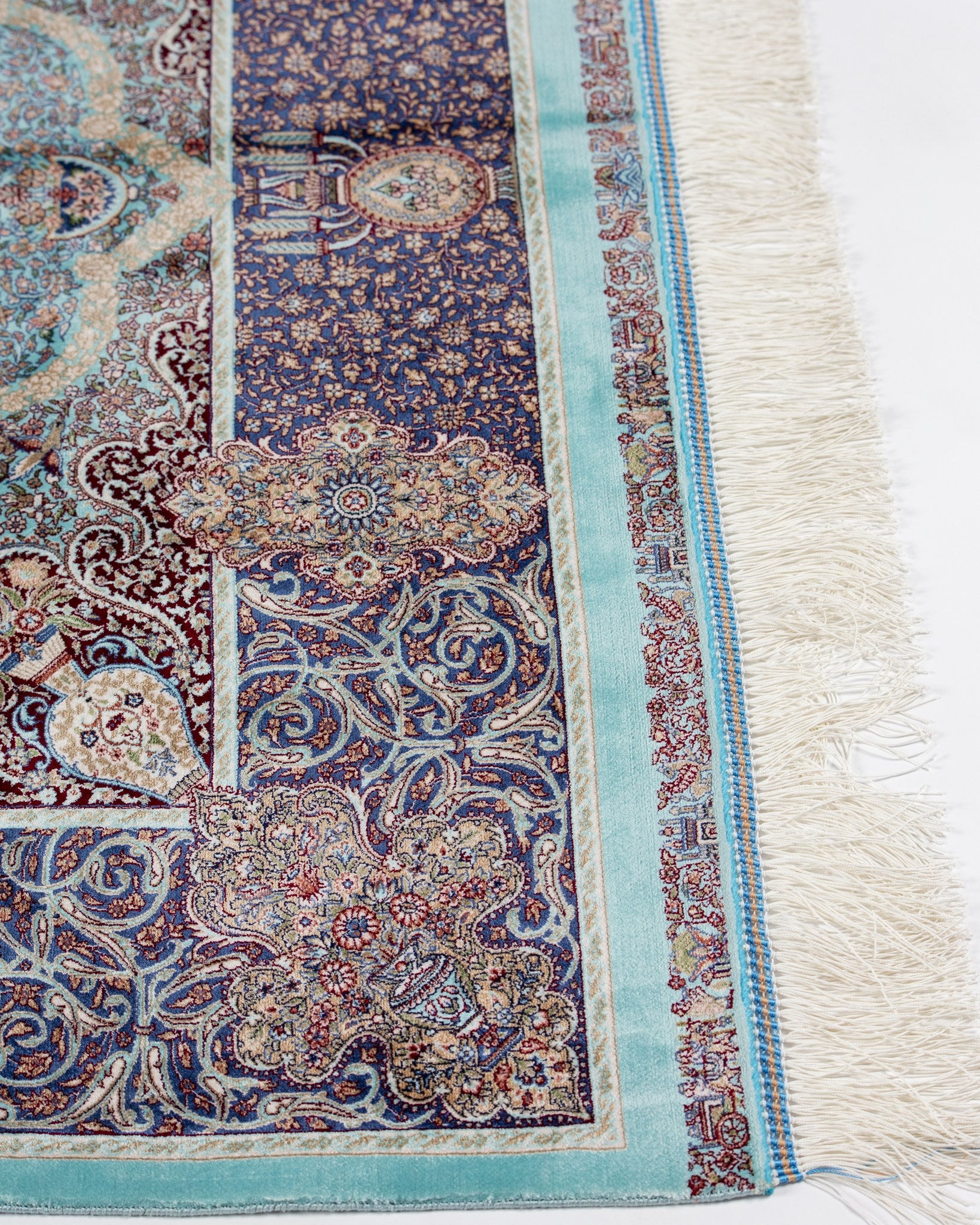 Border of the Banafsheh teal silk rug with silk fringe