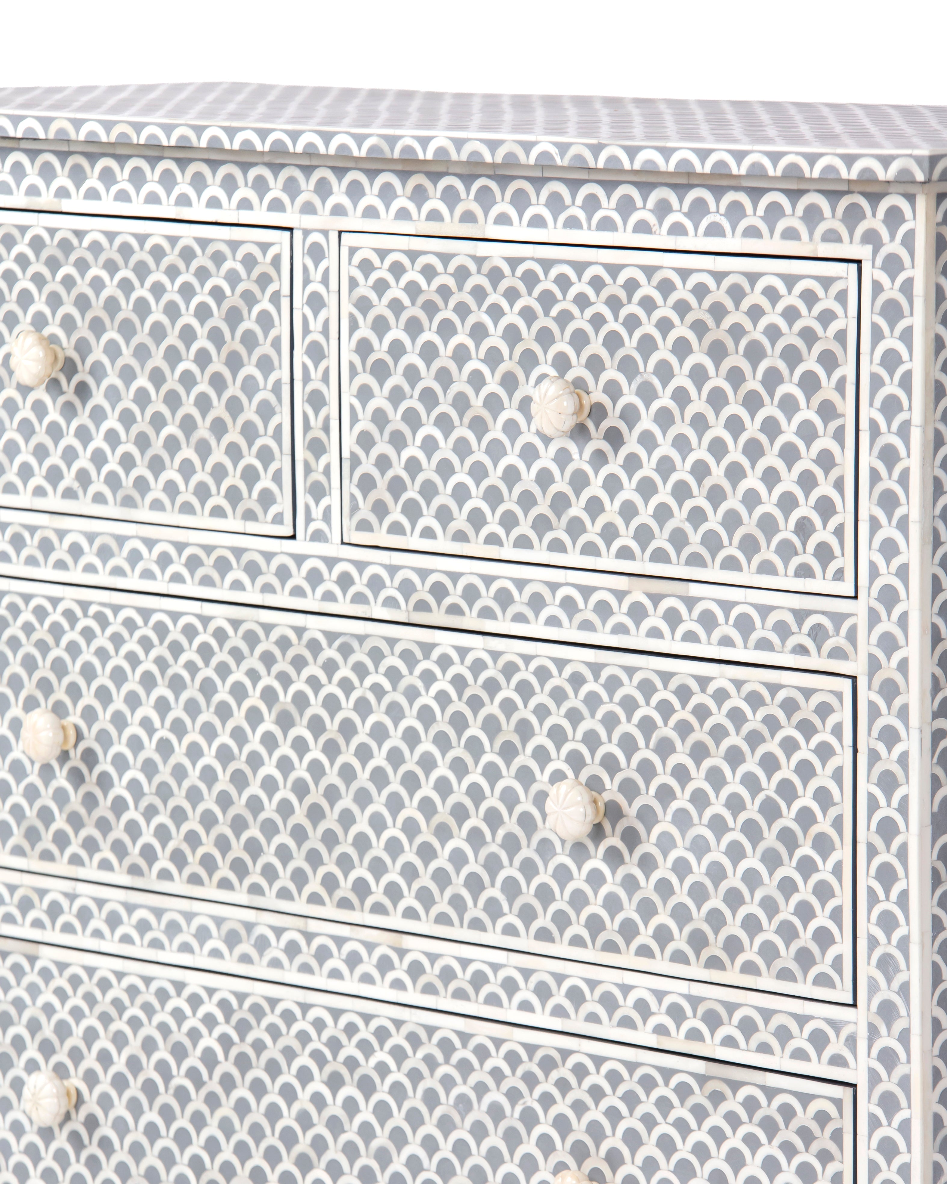 Top drawers with carved bone knobs on Basel grey chest of drawers