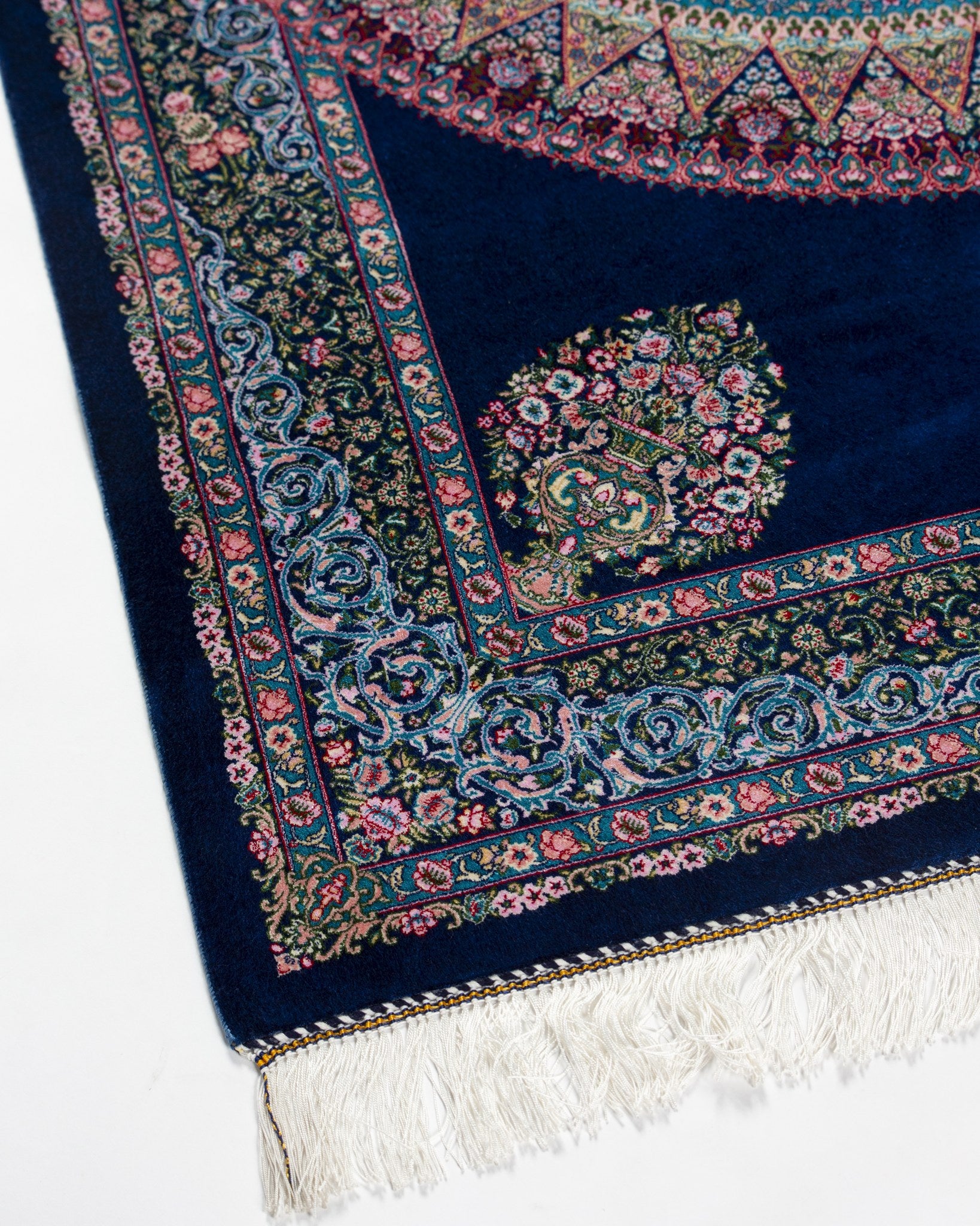 Corner and border detail of the Darya navy silk rug with fringe