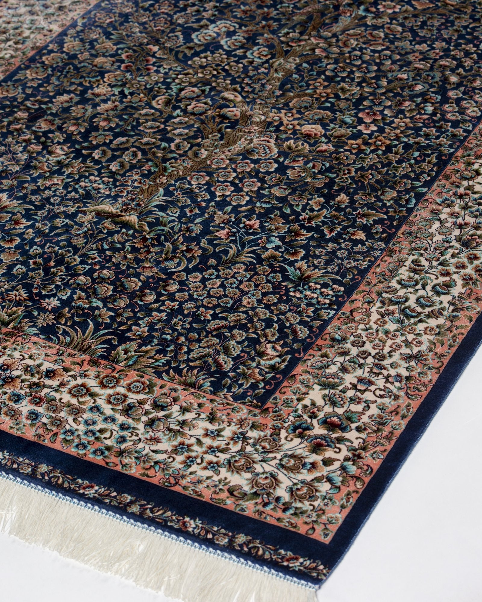 close view of the floral field on the Delkash blue silk rug
