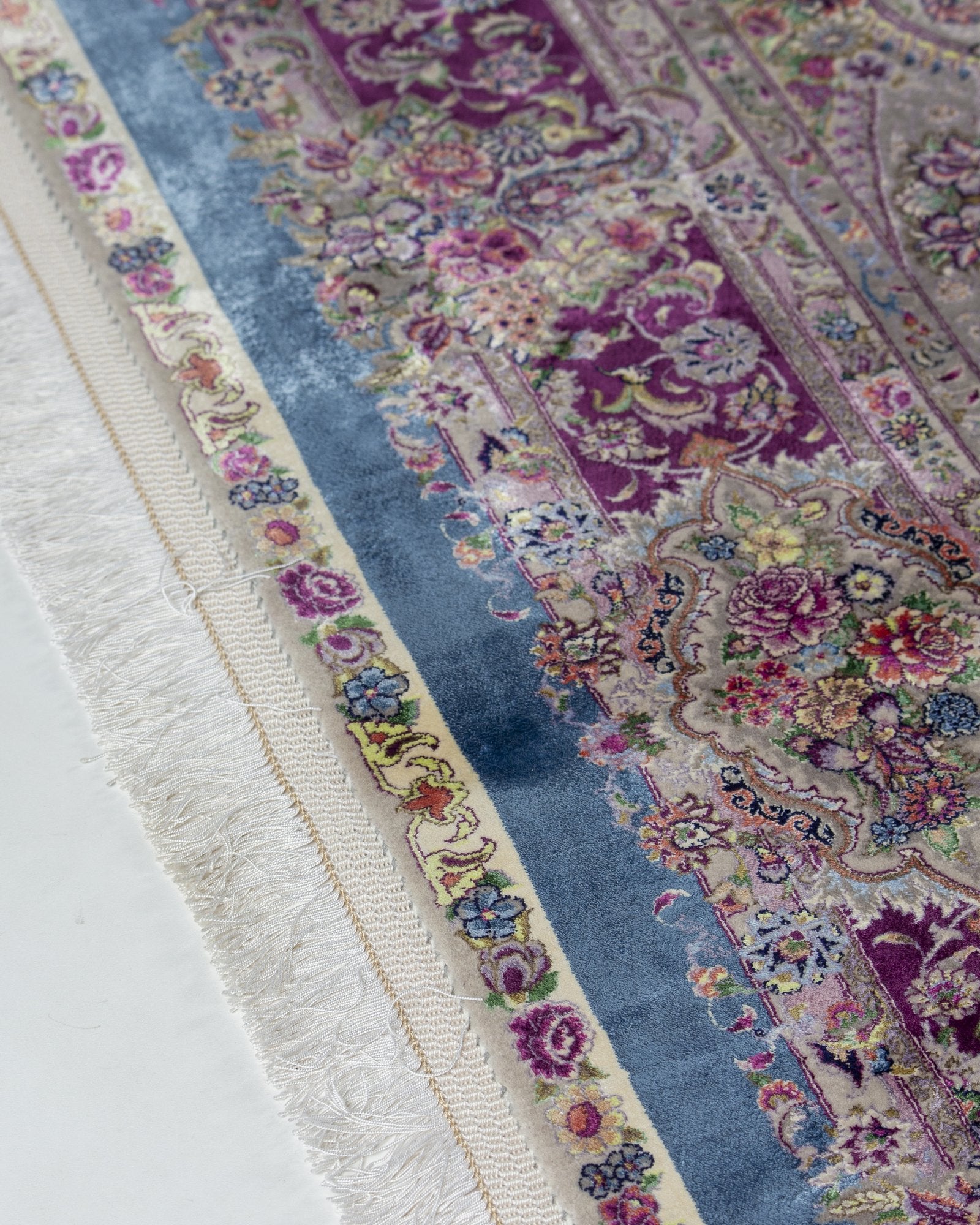 Farahnaz silk and wool carpet angled view showing powder blue tones, 225 x 150 cm - Tabeer Homes Dubai
