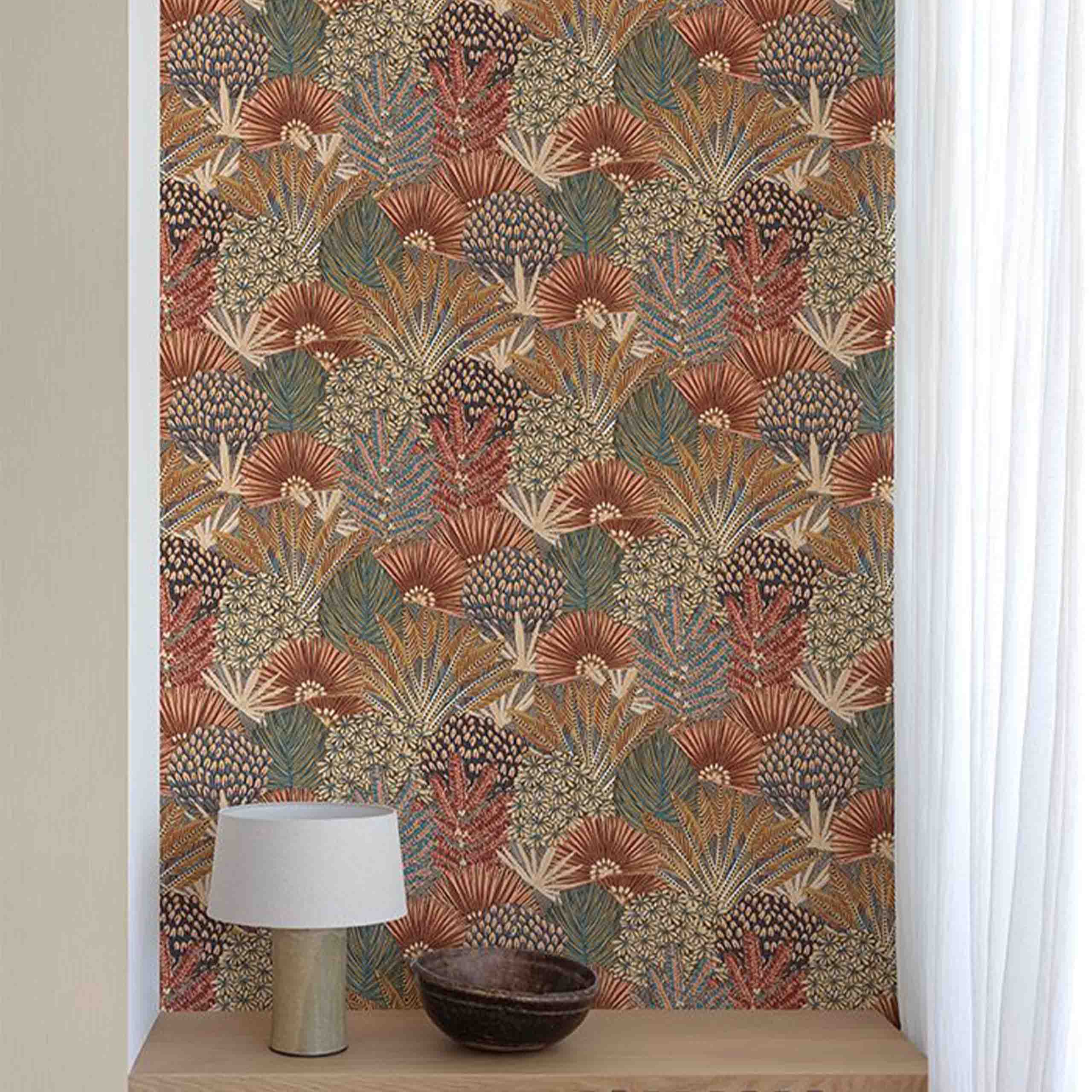 Fiorella wallpaper displayed in a stylish room, showcasing intricate floral and botanical designs in bold blue and red hues.