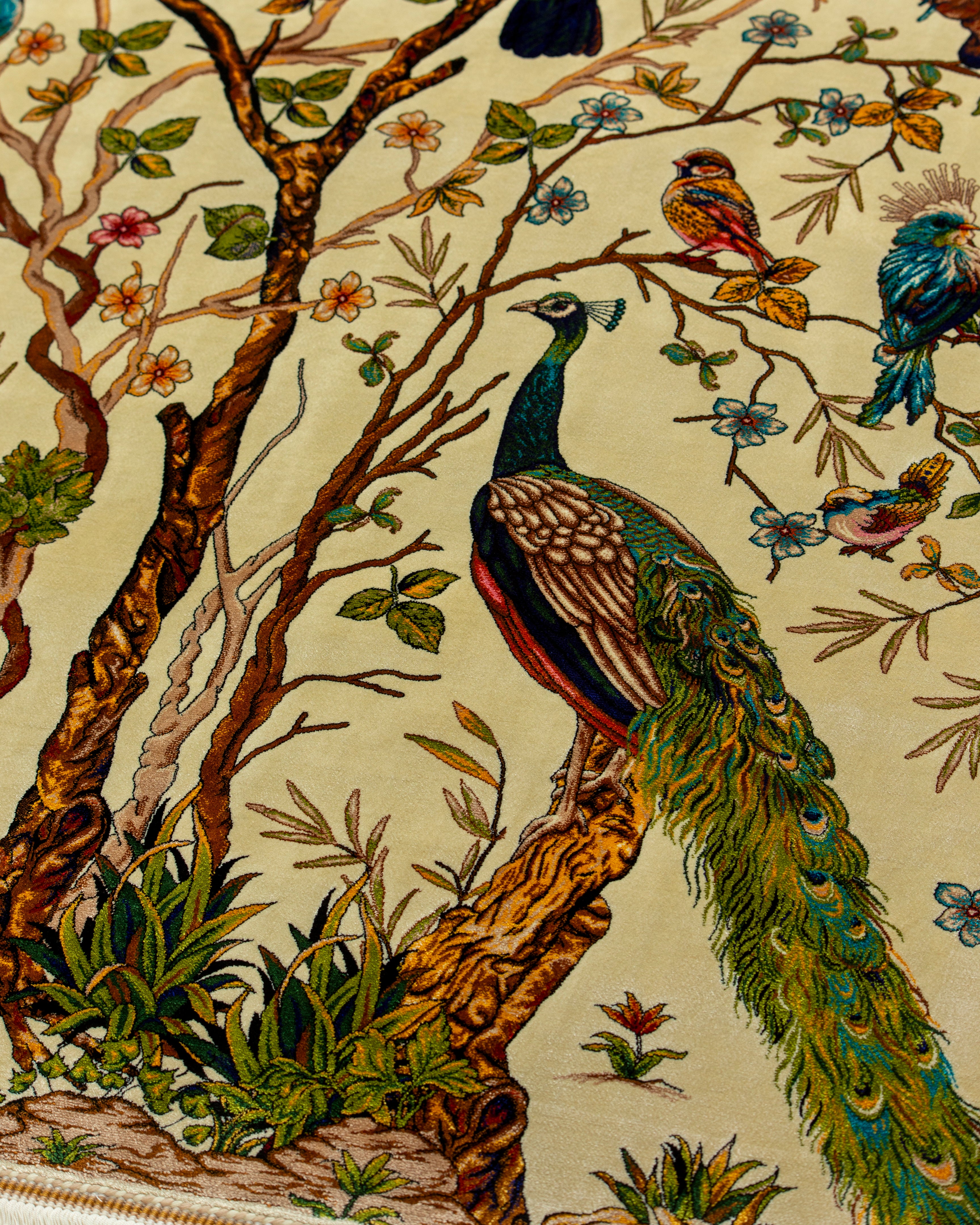 Bird and blossom detail of the Firdaus ivory silk rug
