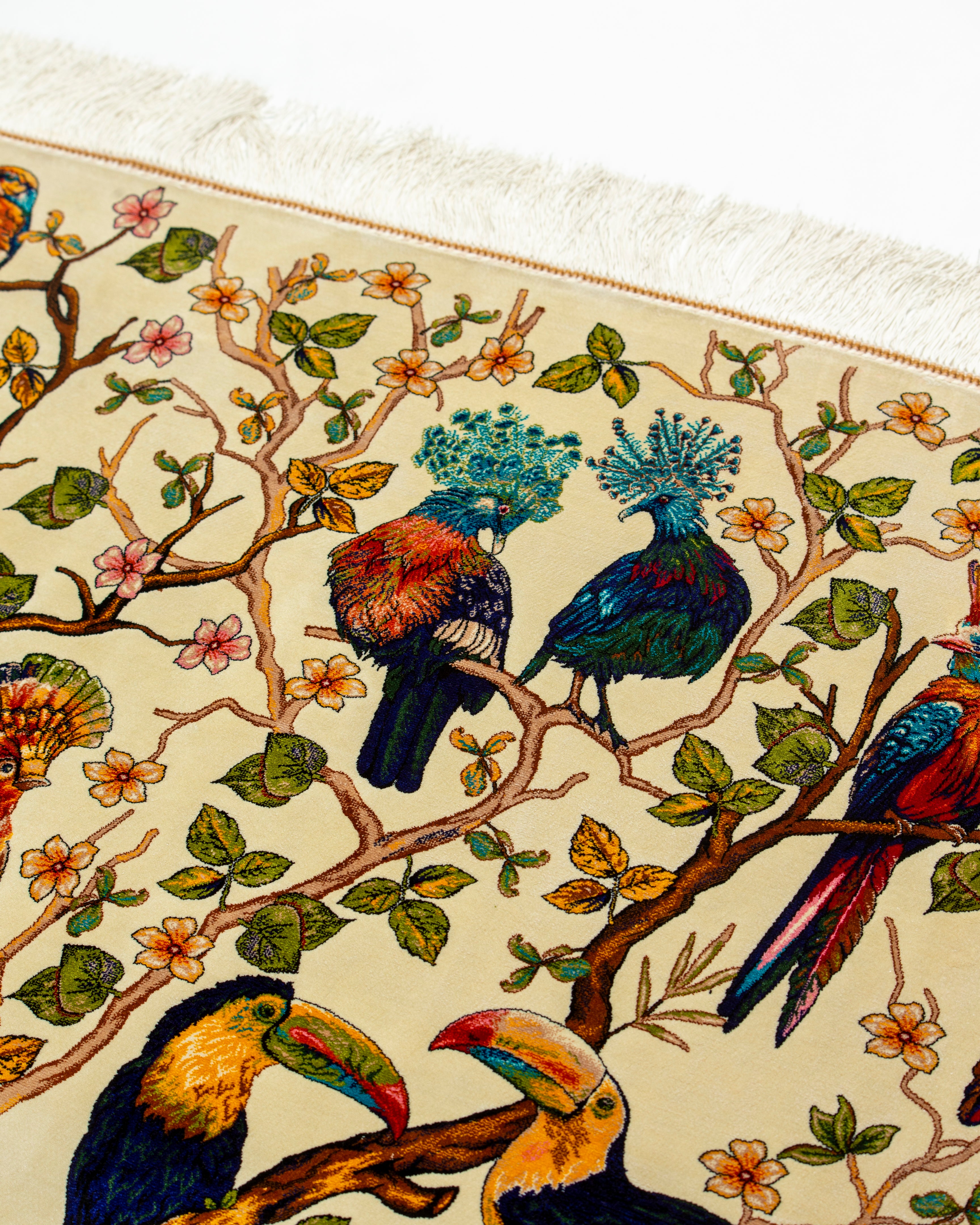 Tree branches and birds detail of the Firdaus silk rug