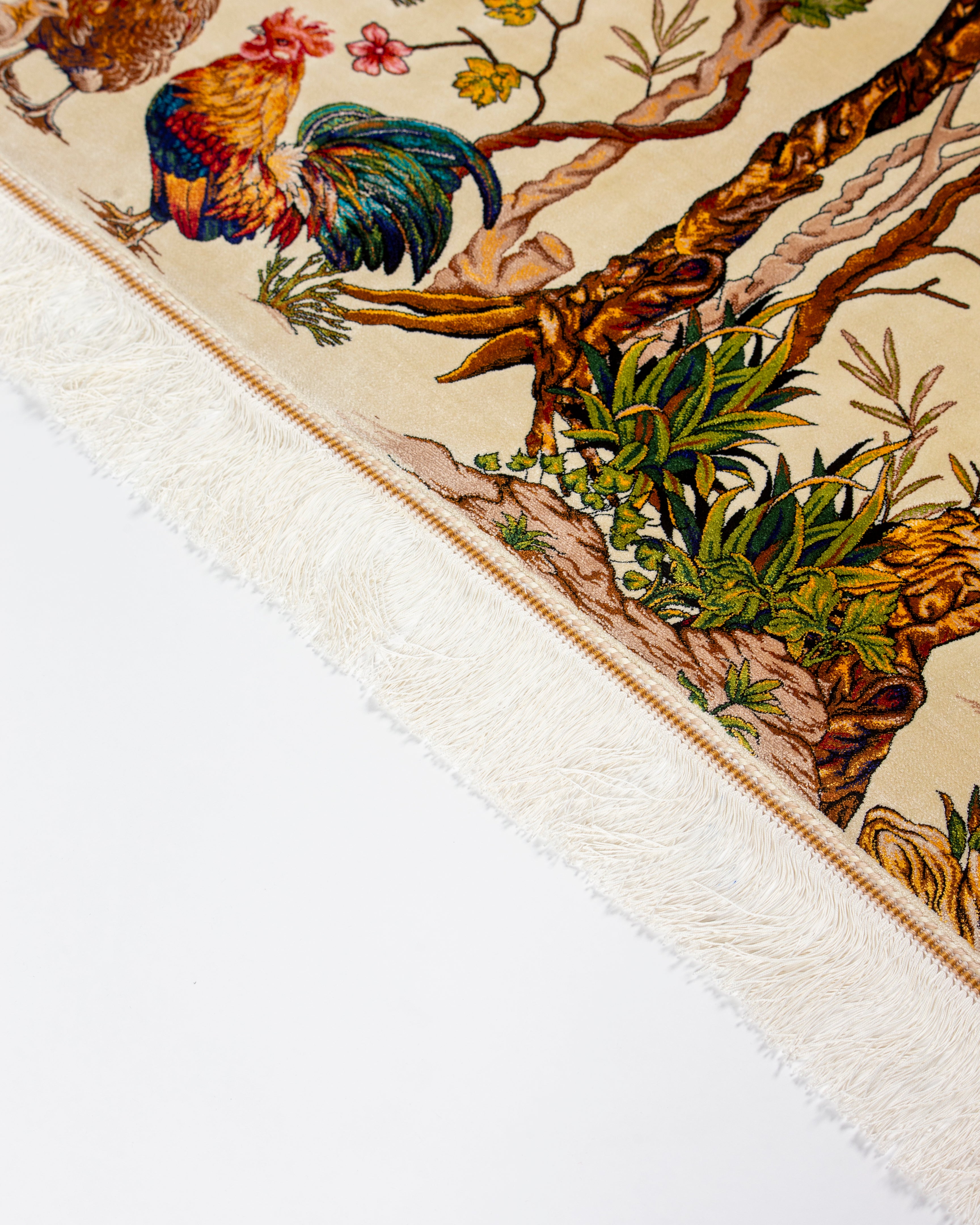 Floral and bird motif detail of the Firdaus ivory silk rug