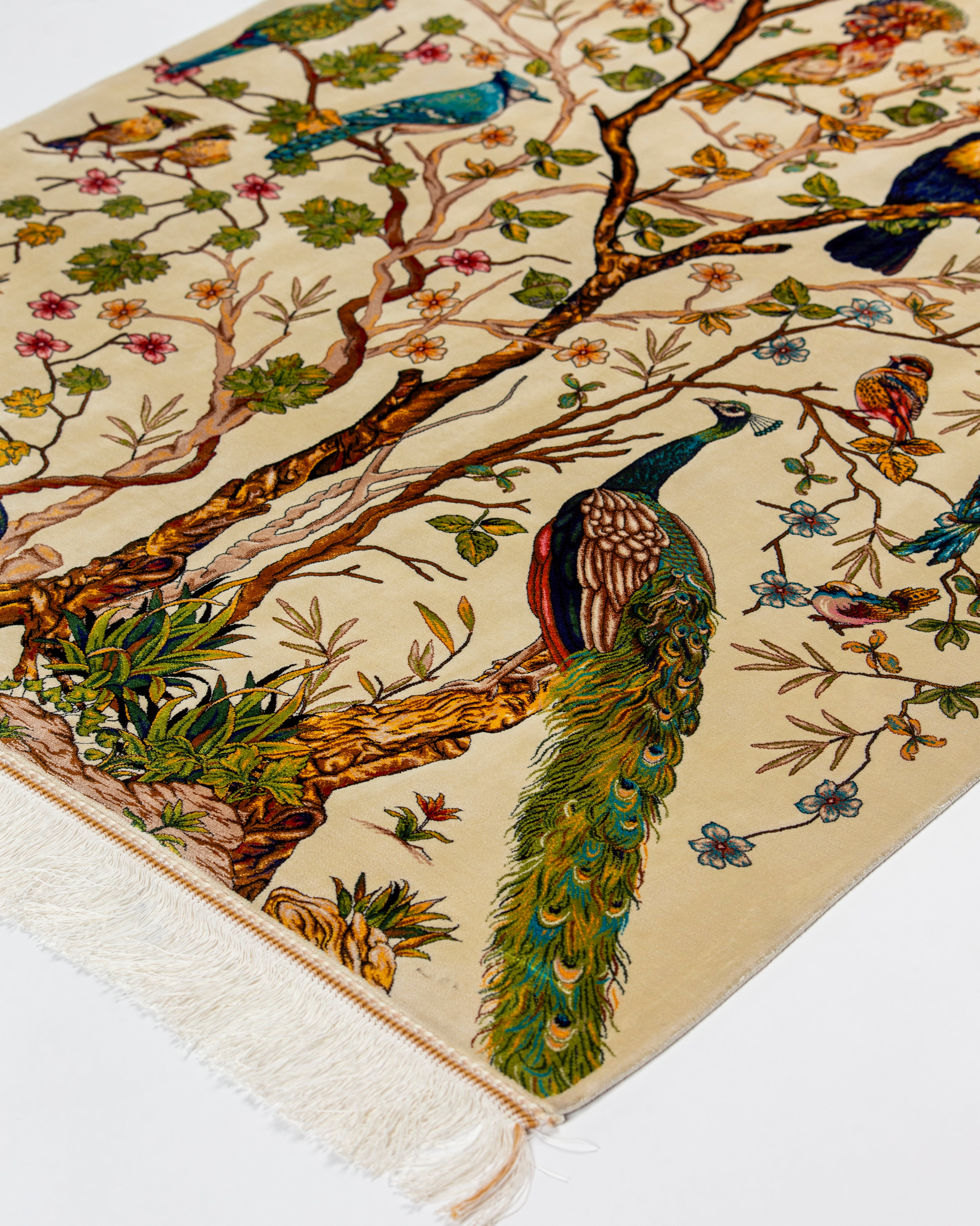 Peacock and birds detail on the Firdaus tree of life silk rug