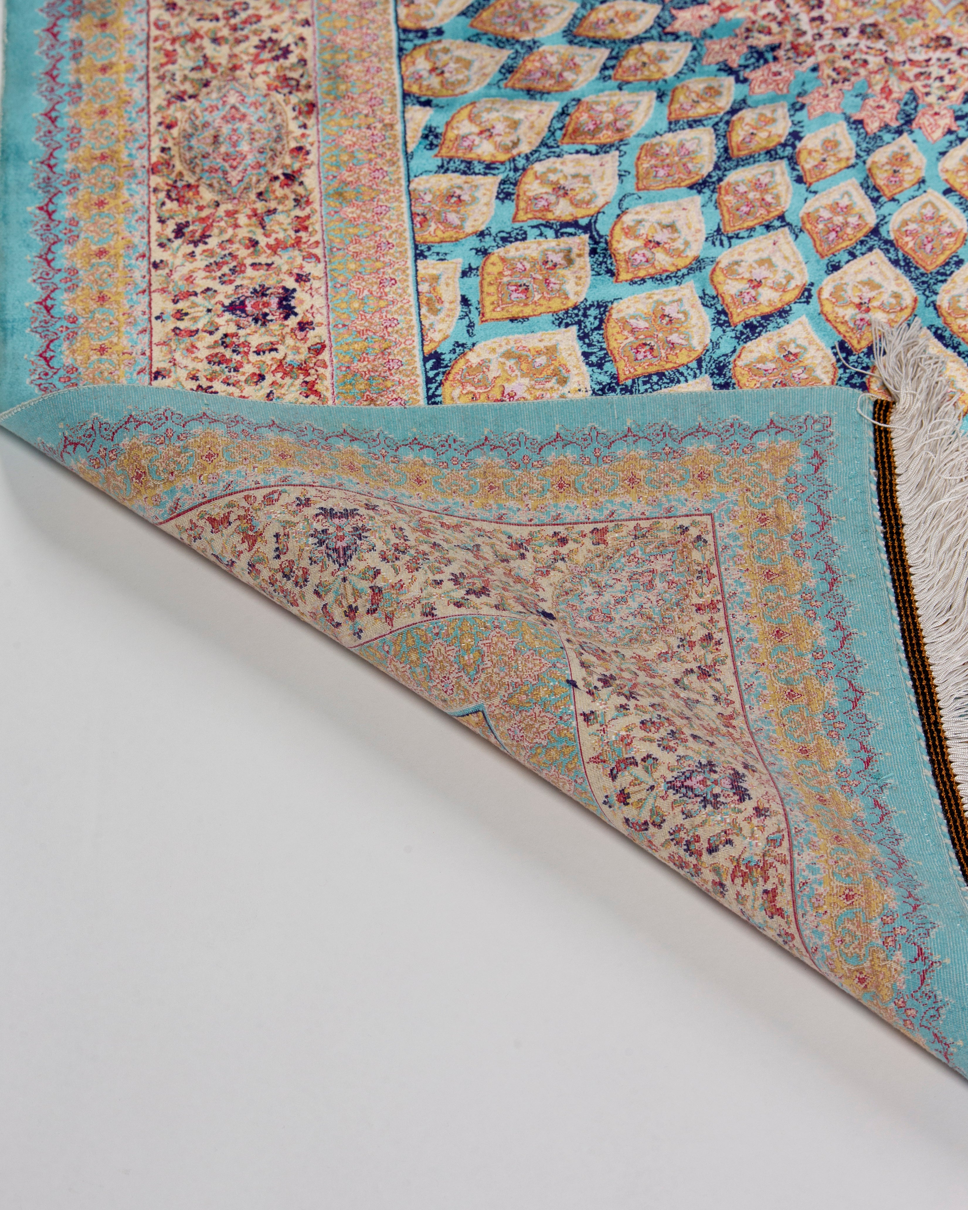 Dome and field detail of the Firuzeh turquoise silk rug