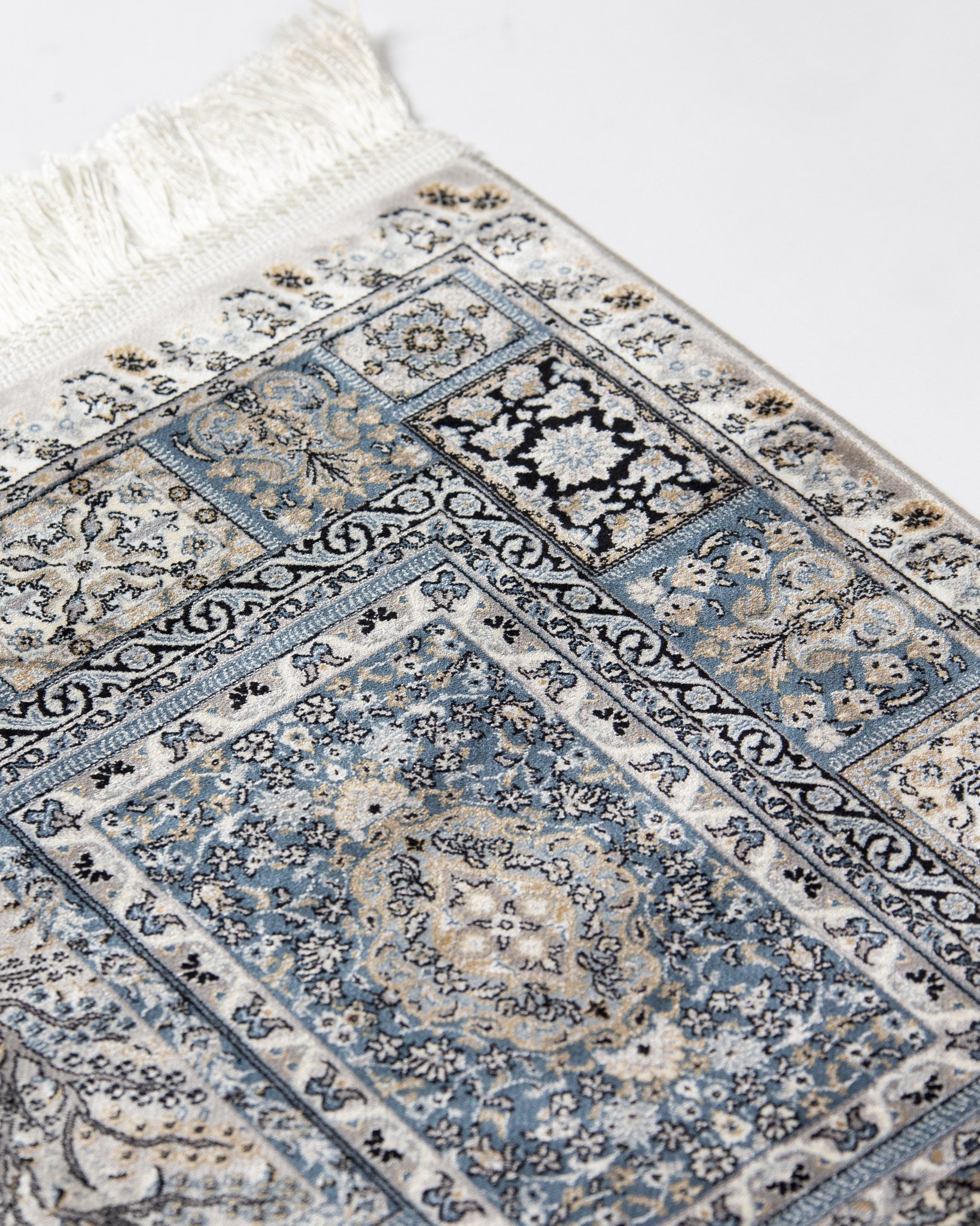 Corner of the Golestan silver grey silk rug