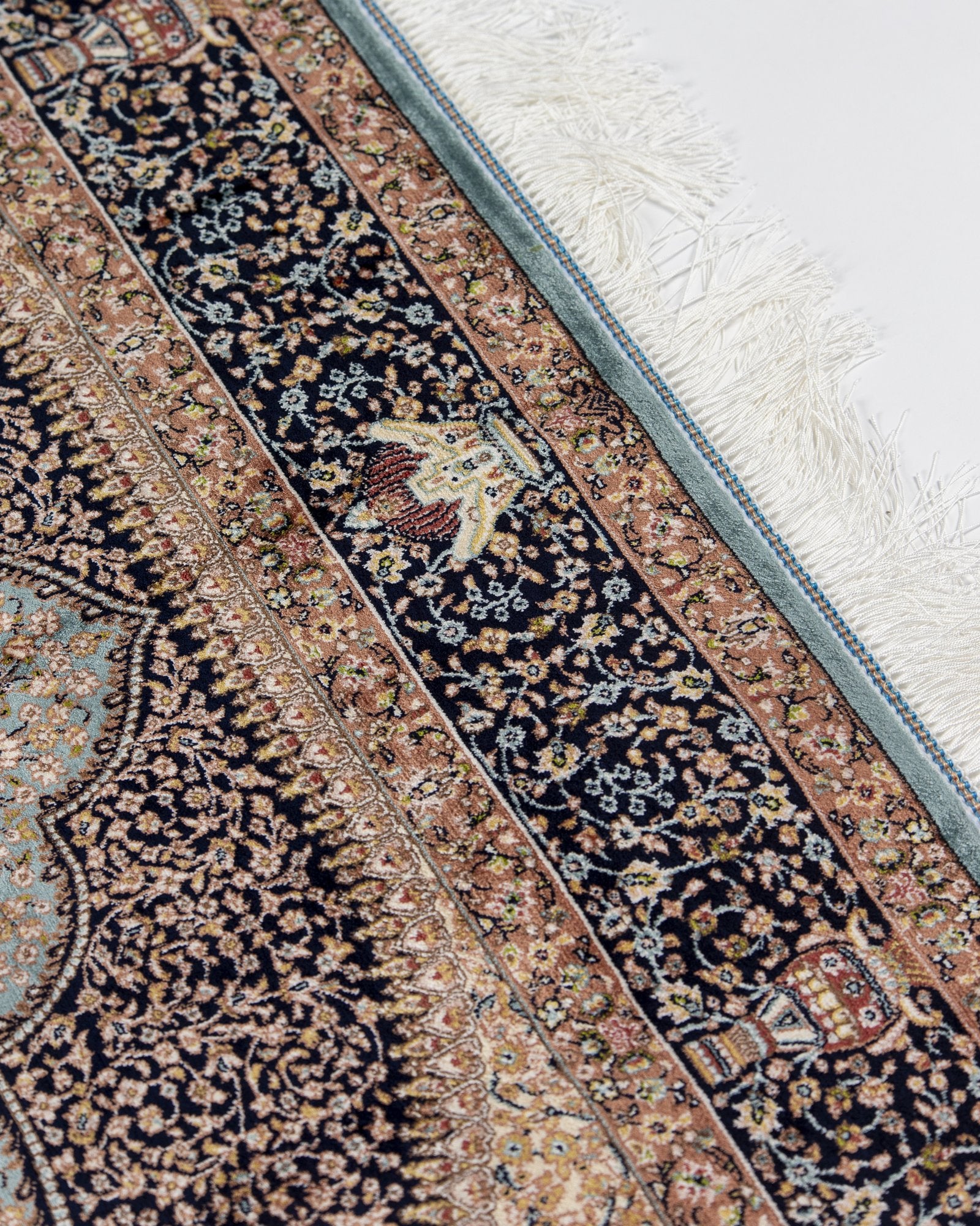 angled view with a fringed end on the Celeste taupe silk rug