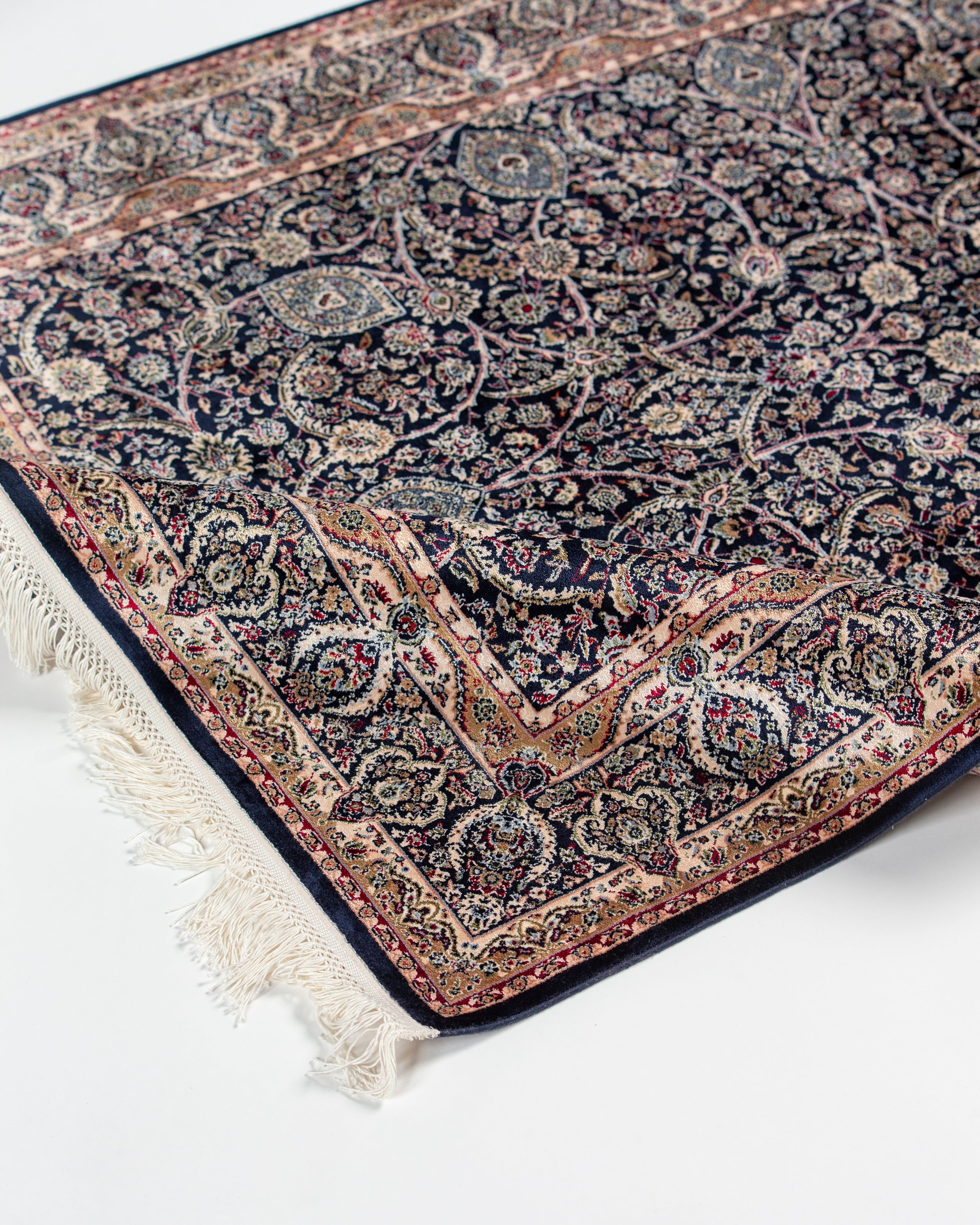 Angled view of Layla silk rug corner and fringe