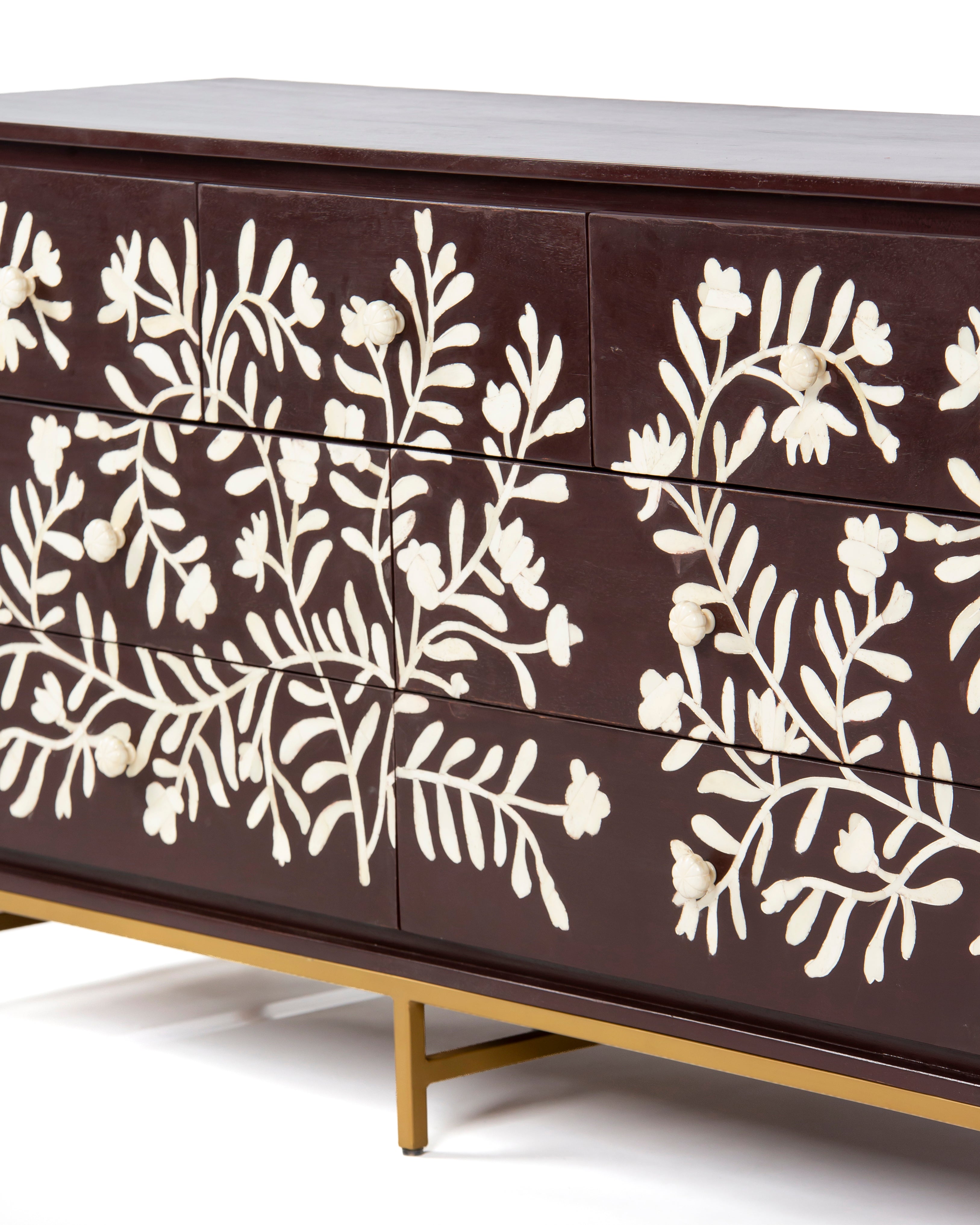 Drawer fronts with white floral bone inlay on burgundy dresser