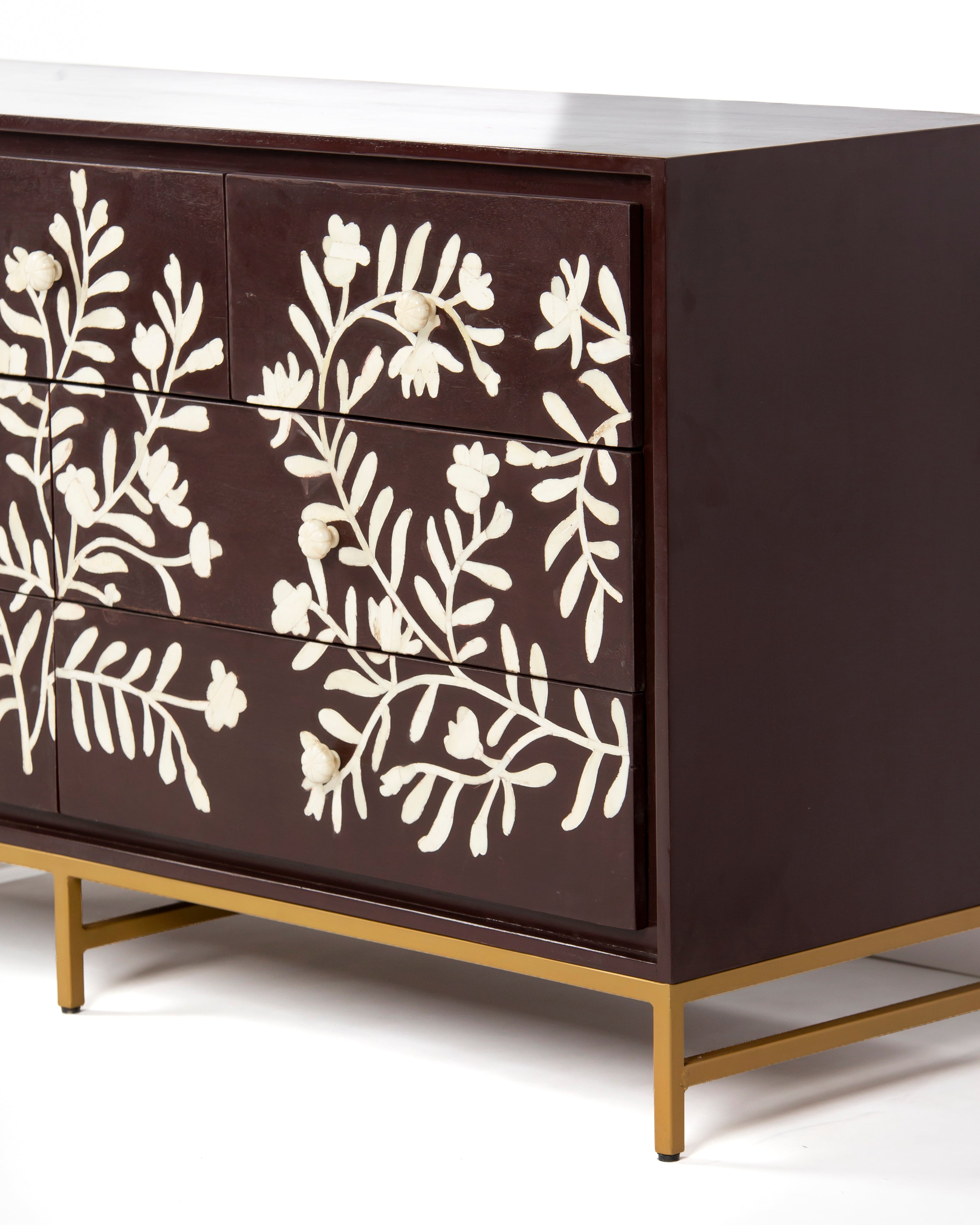 Side corner of Luna burgundy chest of drawers with bone inlay