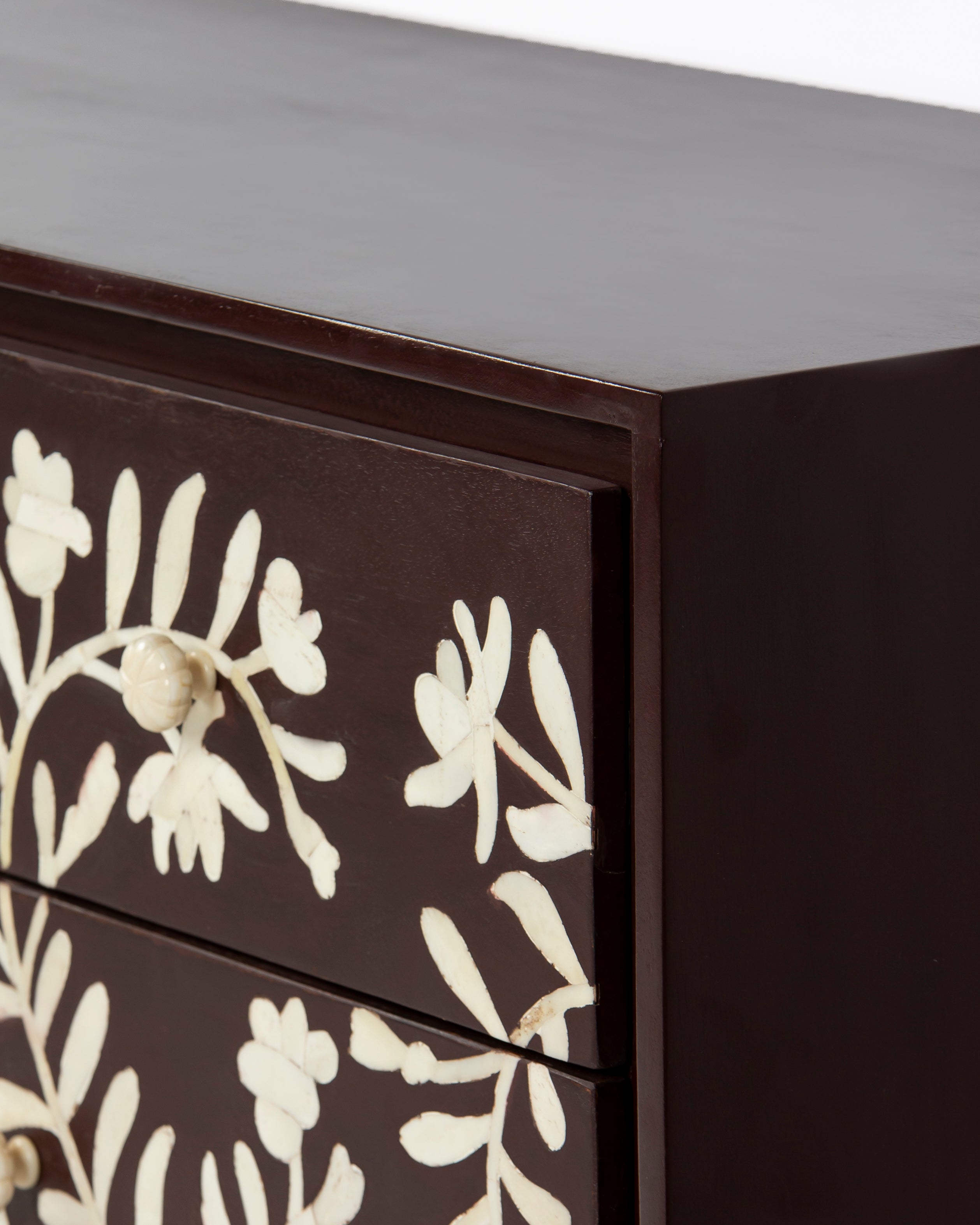 Top corner and bone inlay detail of Luna burgundy chest of drawers