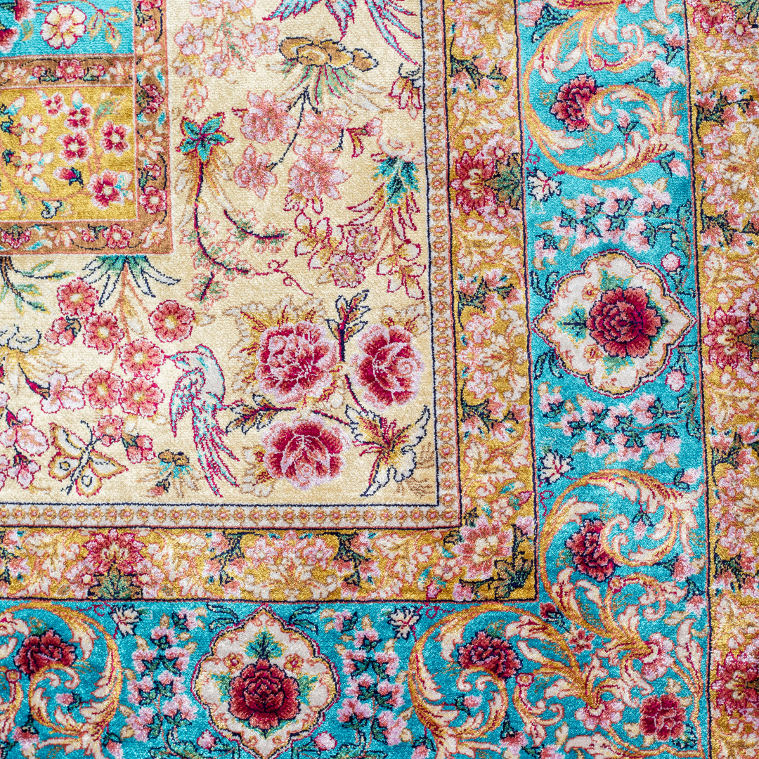Neriah Silk Rug featuring ruby red floral and bird motifs on an aqua-blue base with golden ornate panels, size 150x100 cm.