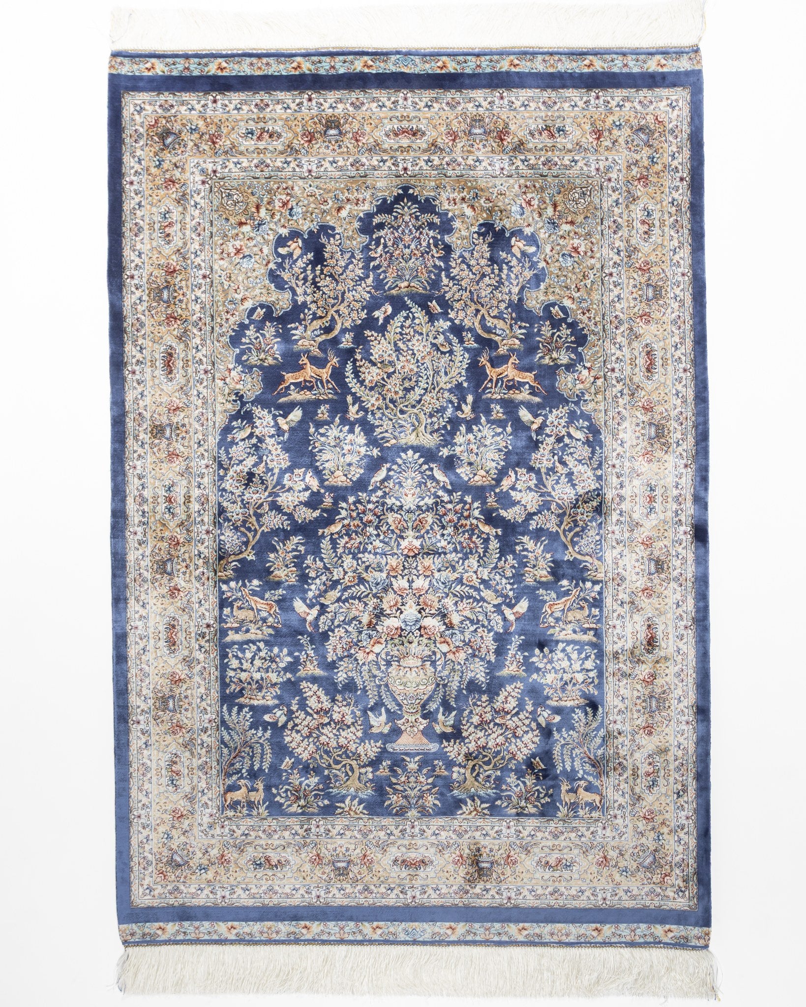 Nilofar blue silk rug 150 x 100 cms with a Persian floral medallion and ivory border