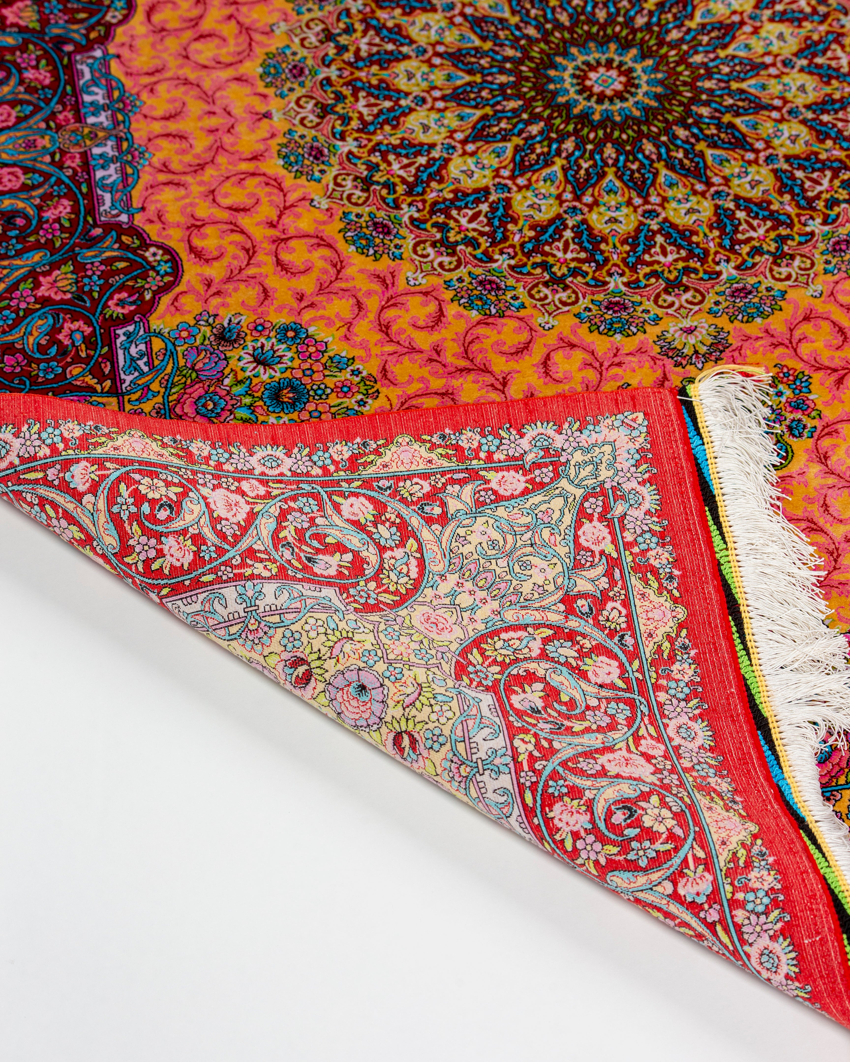 Back corner and border of the Noor coral Persian silk rug