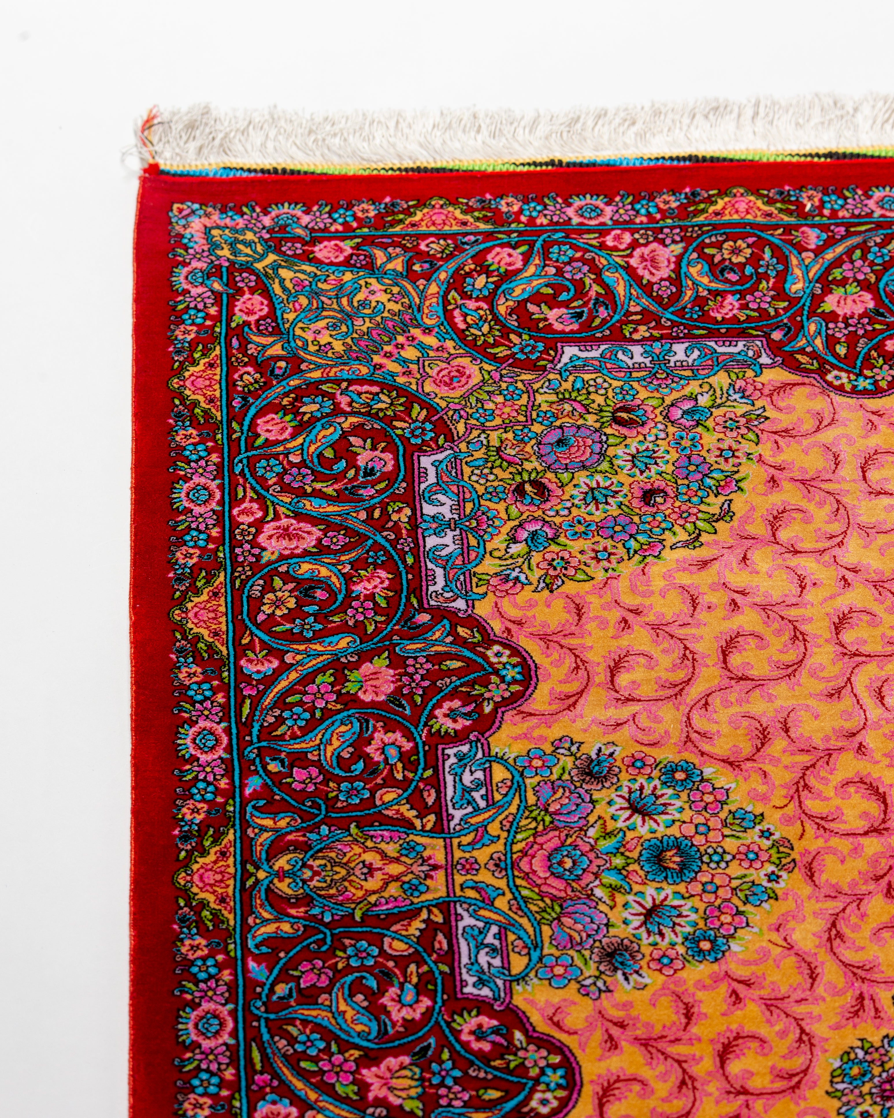Red border detail of the Noor coral Persian silk rug
