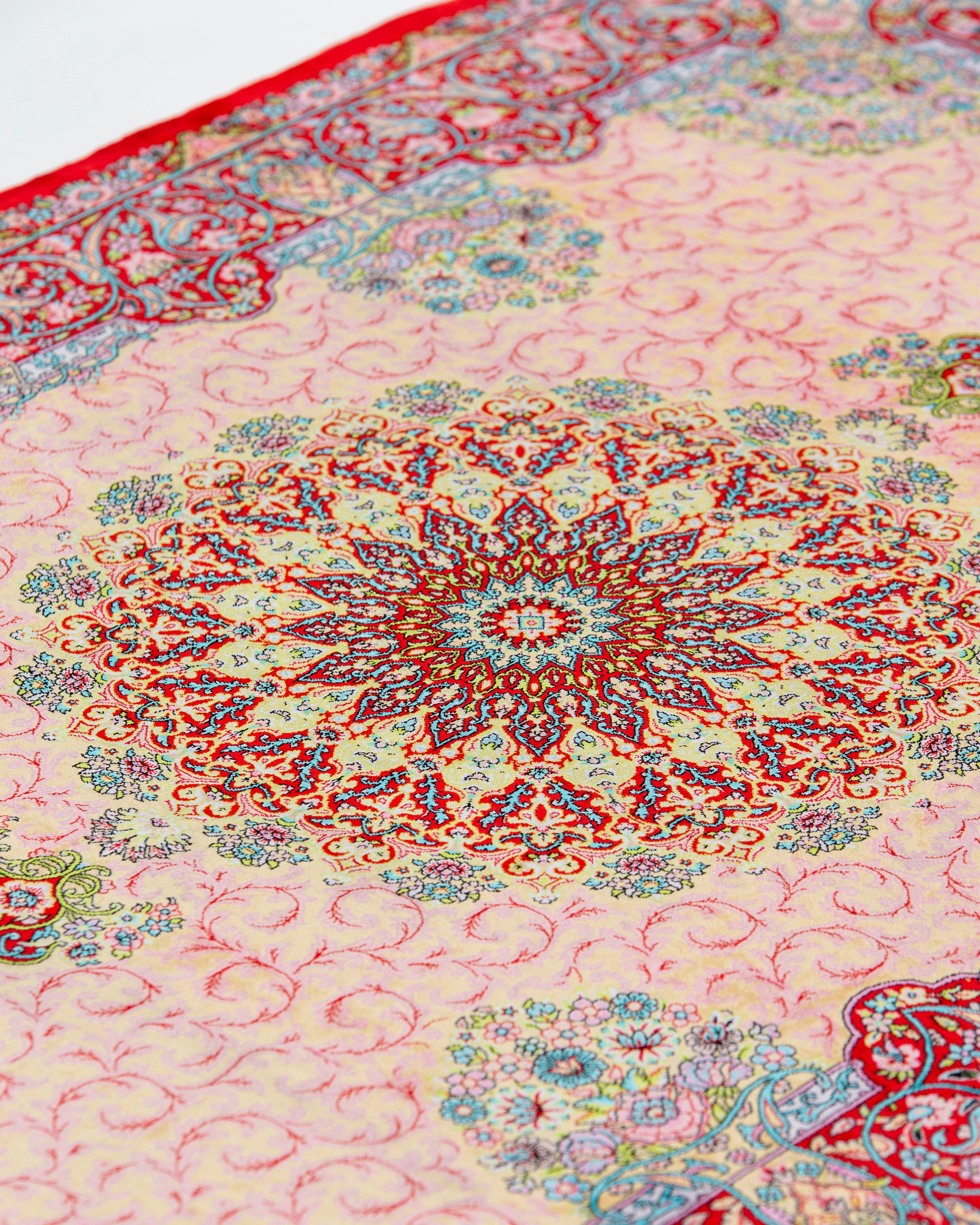 Central starburst medallion detail of the Noor coral silk rug