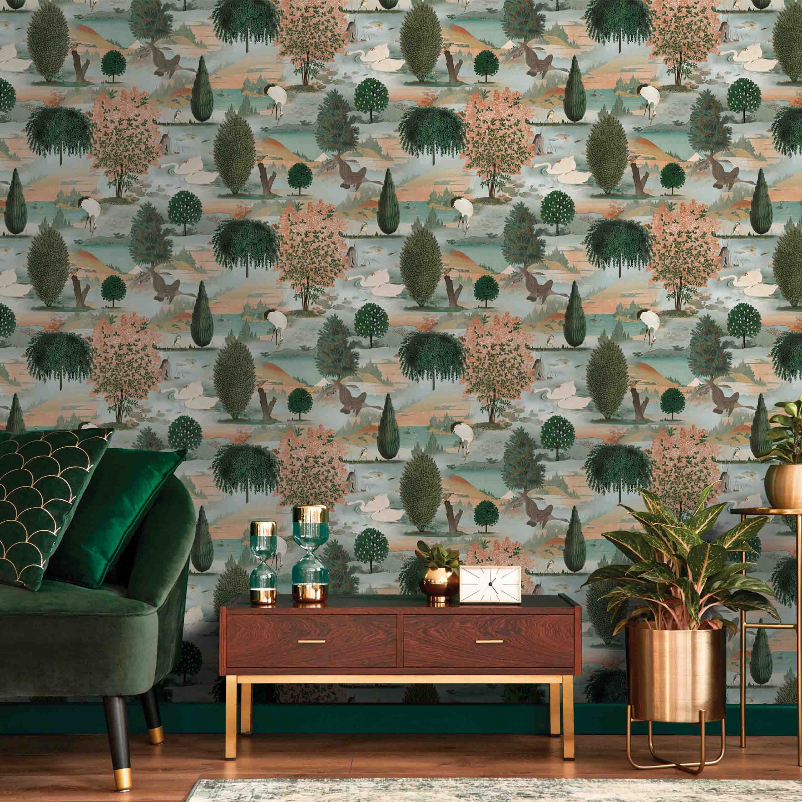 Orvana wallpaper displayed in a modern living room setting, showcasing elegant botanical and bird motifs in green, light brown, and orange tones.