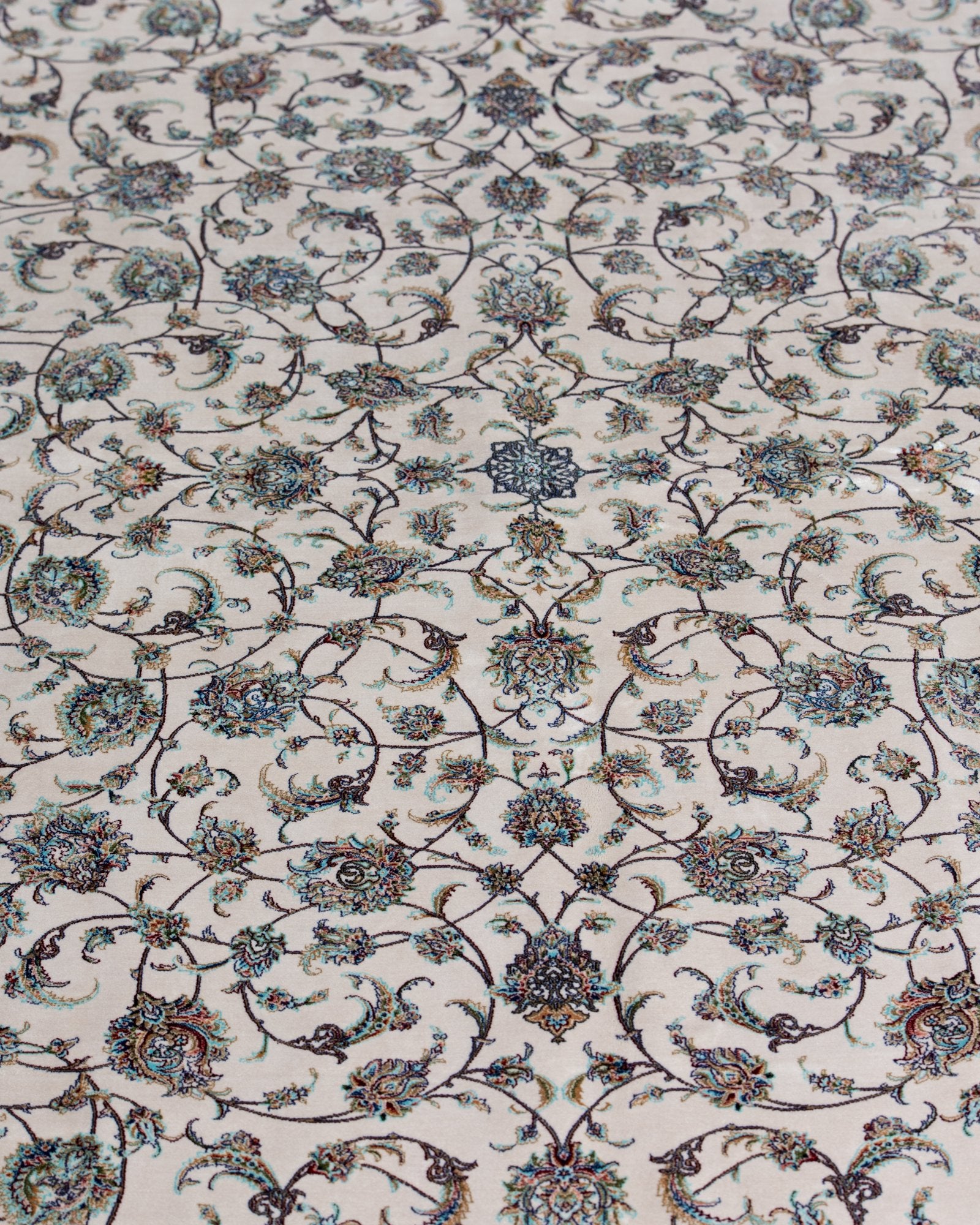 close view of the floral field on the Parisa ivory silk rug