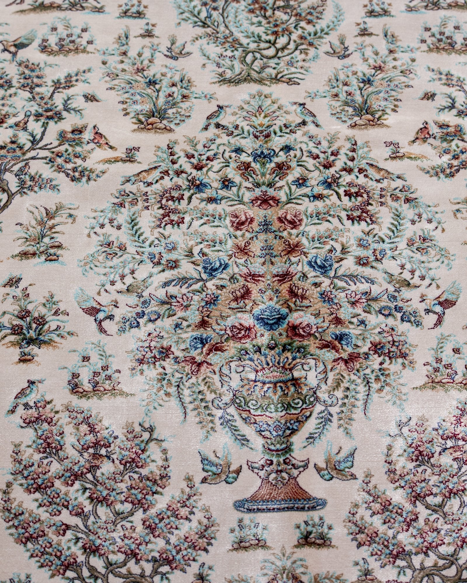 angled view with a fringed end on the Parvaneh ivory silk rug
