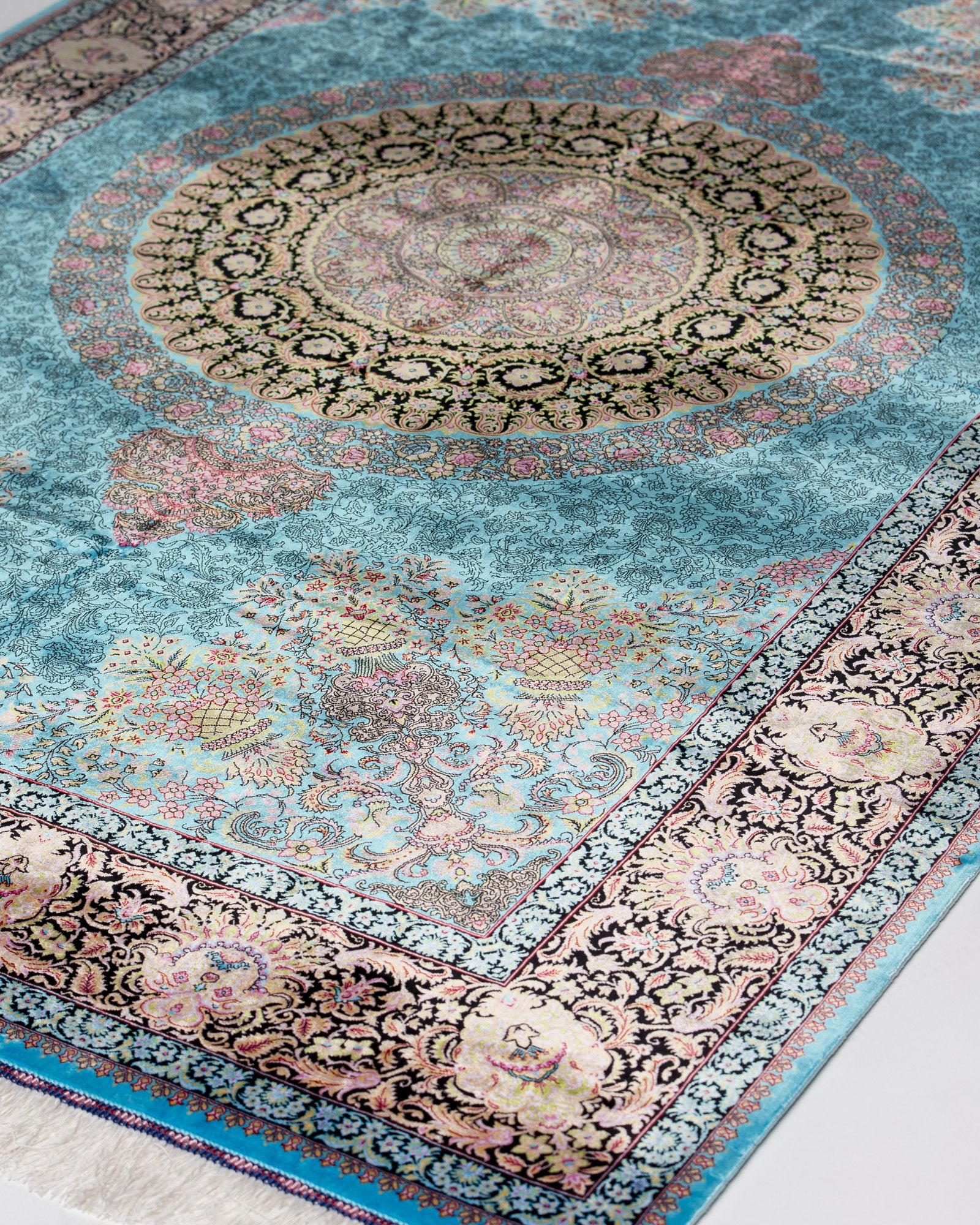 corner with silk fringe on the Serena turquoise silk rug
