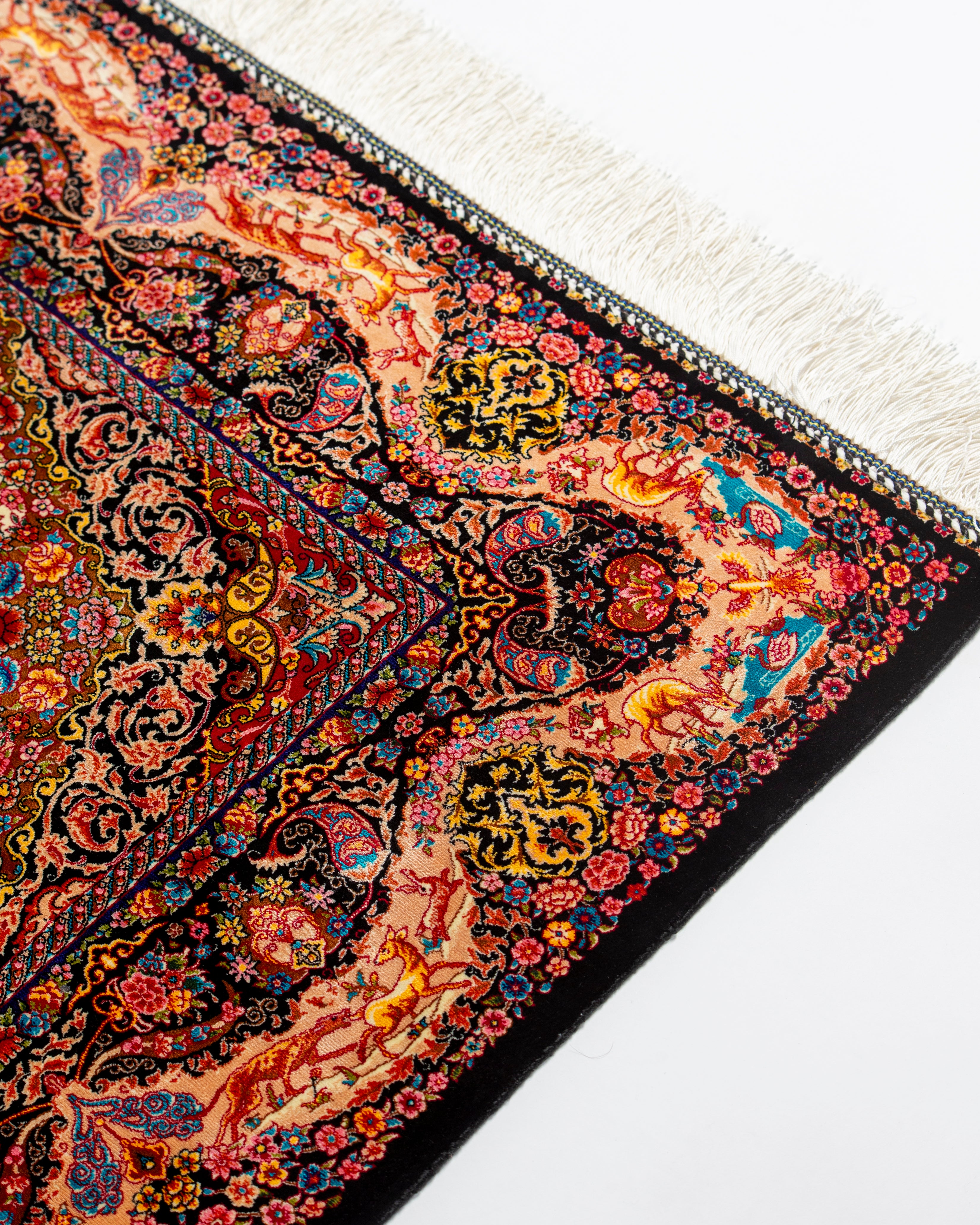 Animals and foliage detail on the Shirin silk rug