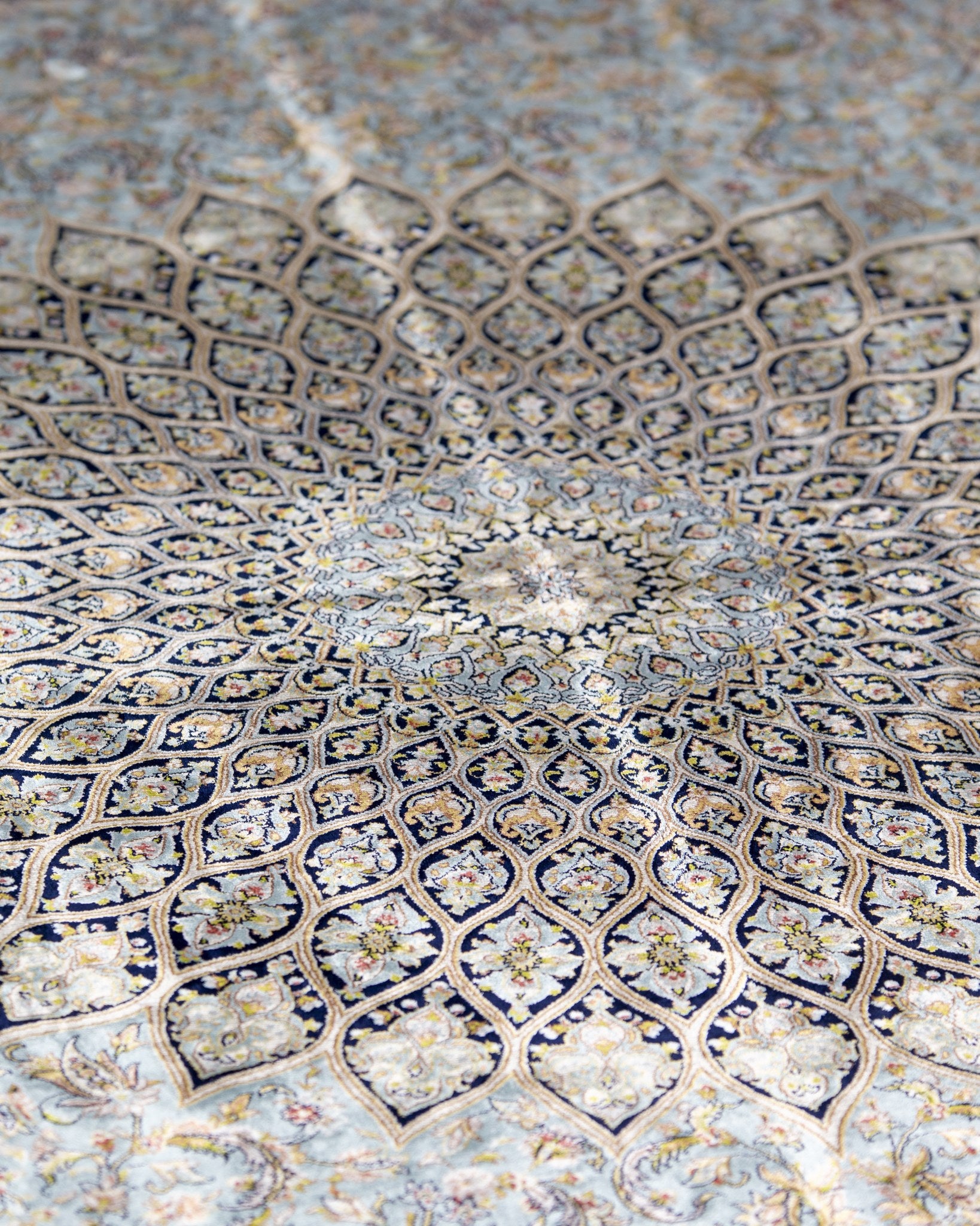 Close view of the Sitareh silk rug star medallion in ivory and gold