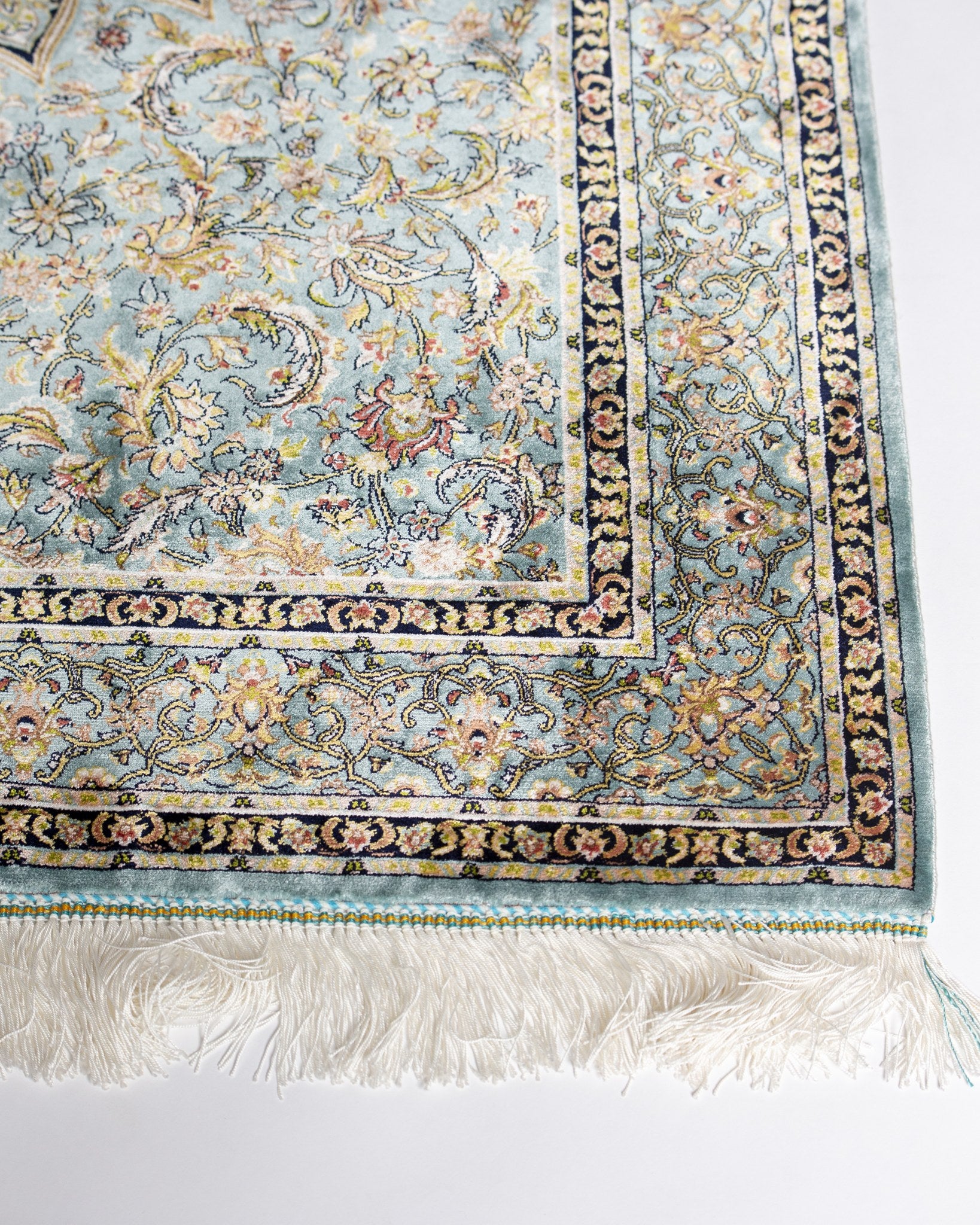 Corner and border of the Sitareh silk rug with silk fringe