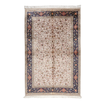 Ivory silk rug with intricate floral patterns in navy, rose, gold, and turquoise, framed with an ornate navy border.


