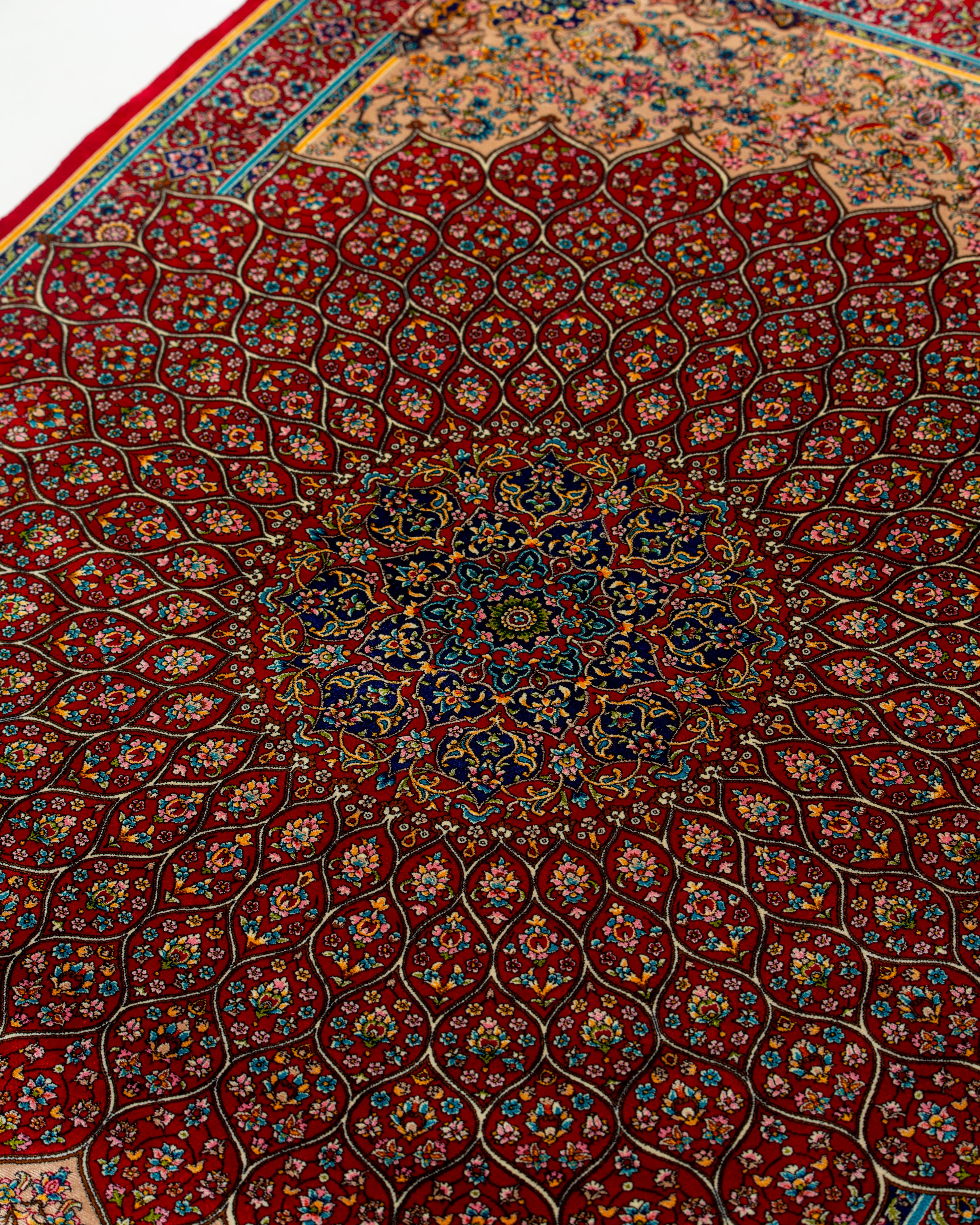 Floral field detail of the Soraya red Persian silk rug