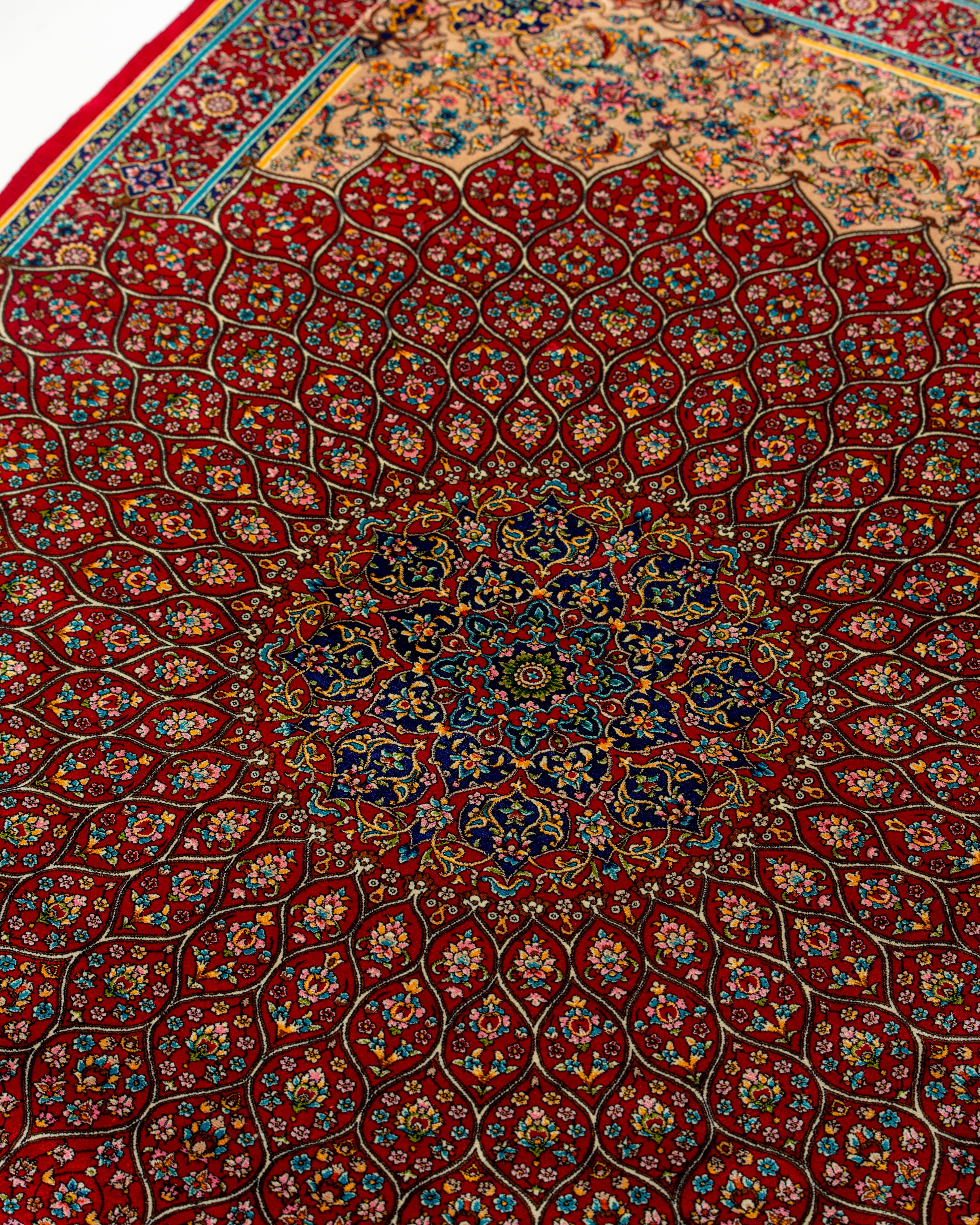 Angled view of the central medallion on the Soraya red silk rug