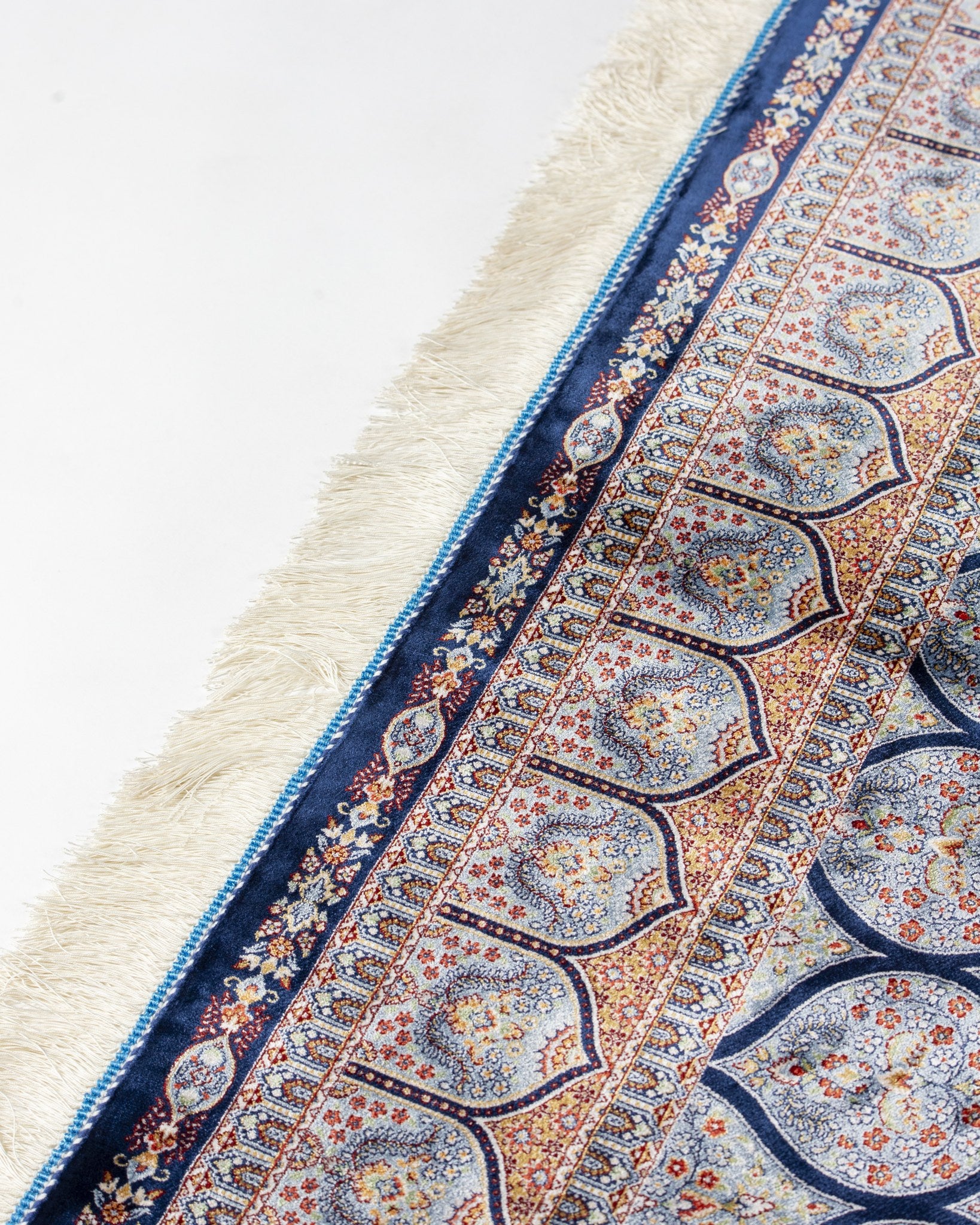 Border of the Tavoos blue silk rug with silk fringe