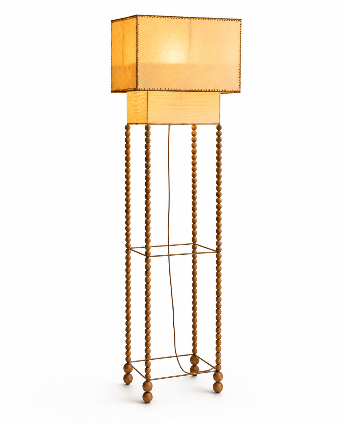 The Abacus Floor Lamp by The Qratist features a handcrafted brass finished metal frame with hand turned wooden spheres and layered parchment paper shades, creating a sculptural floor lamp inspired by the timeless elegance of an abacus.