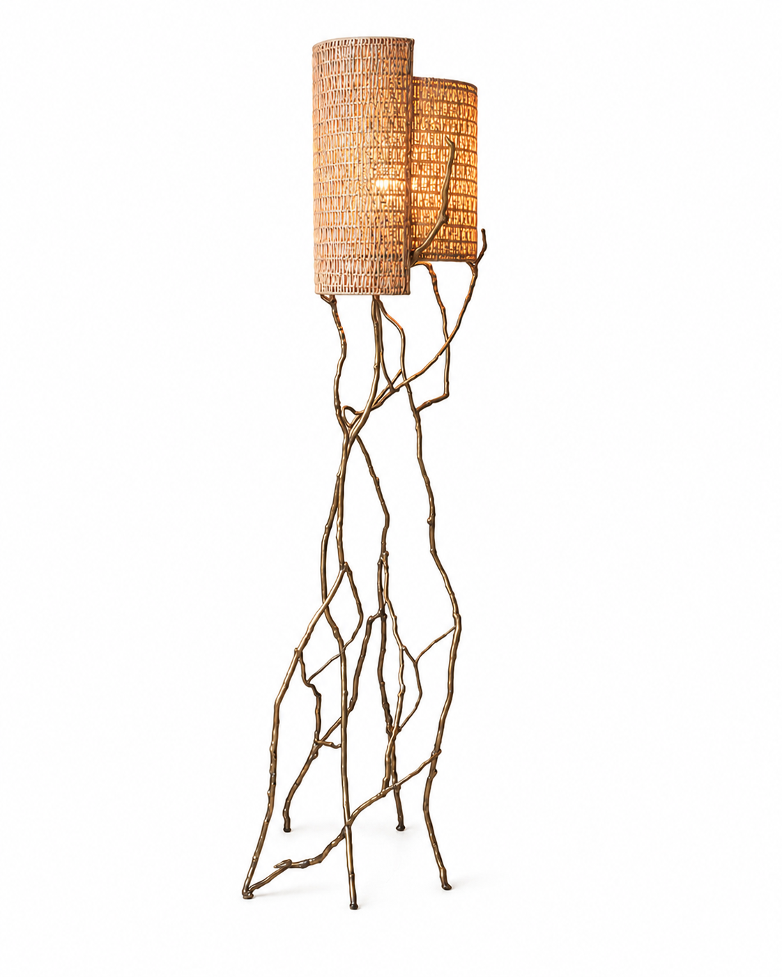 The Banyan Floor Lamp by The Qratist features a sculptural patinated gold brass frame inspired by banyan tree roots with handcrafted woven cane shades, creating a warm and elegant nature inspired lighting statement.