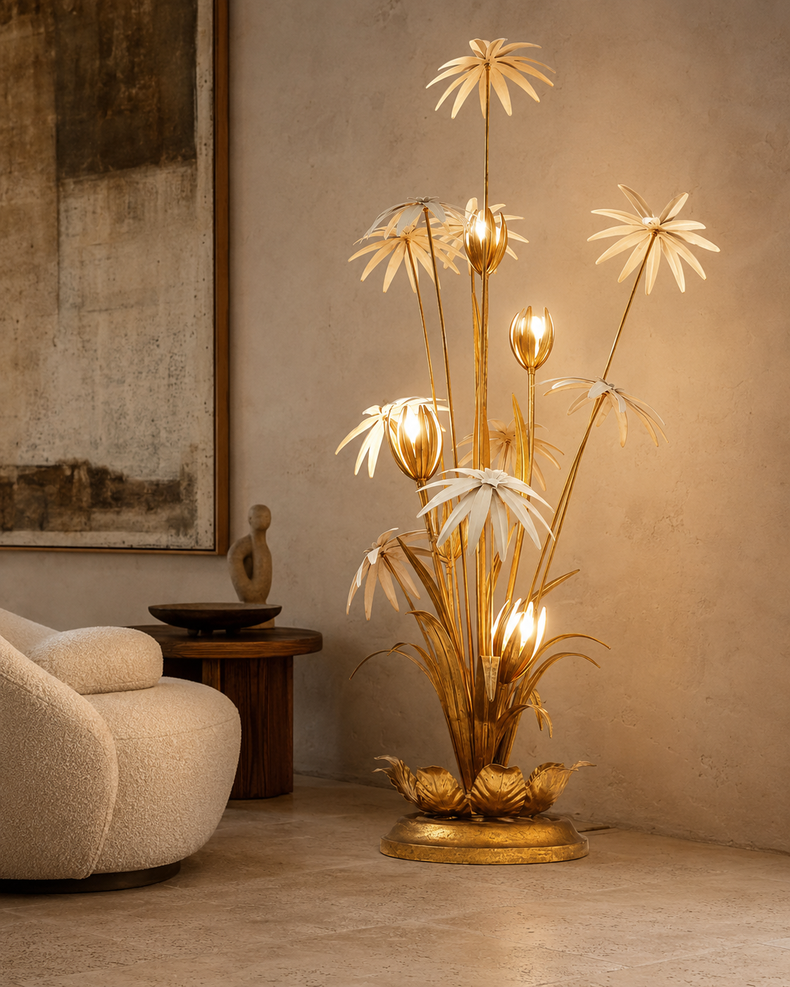 The Bouquet Floor Lamp by The Qratist features handcrafted gold and bronze finished metal flowers and foliage arranged in a sculptural botanical composition, creating warm ambient illumination.