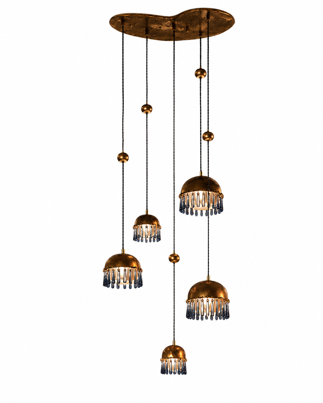 The Chime Chandelier by The Qratist features polished brass dome pendants with handcrafted porcelain drops suspended in a cascading cluster arrangement, creating an elegant sculptural lighting statement.