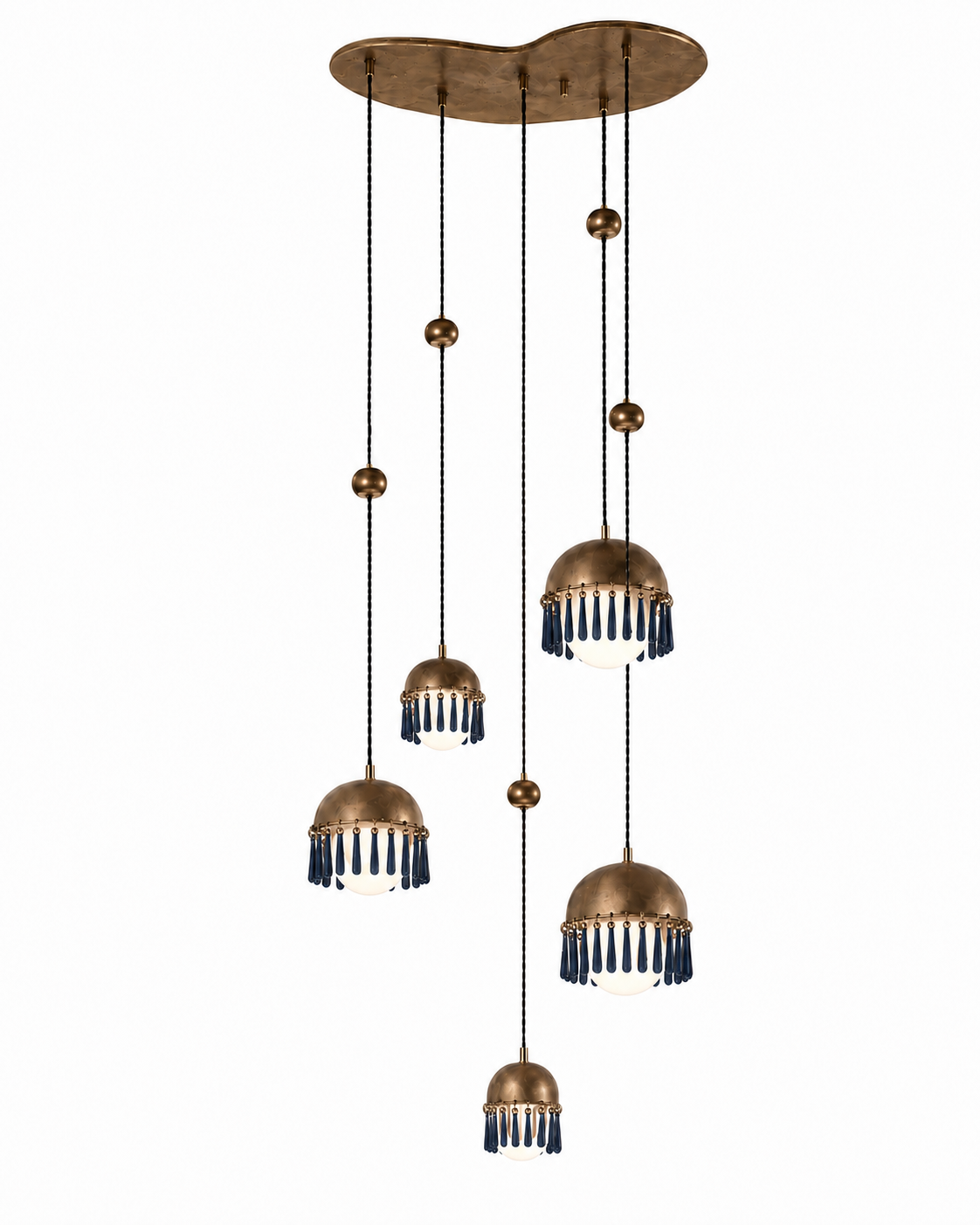 The Chime Chandelier by The Qratist features polished brass dome pendants with handcrafted porcelain drops suspended in a cascading cluster arrangement, creating an elegant sculptural lighting statement.