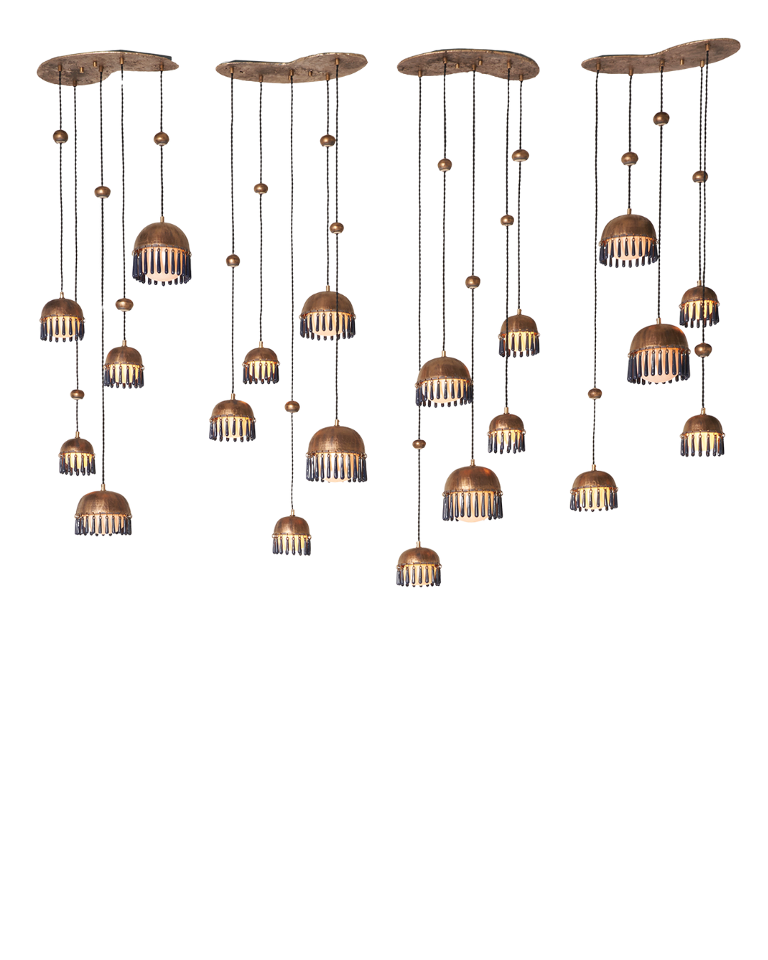 The Chime Chandelier by The Qratist features polished brass dome pendants with handcrafted porcelain drops suspended in a cascading cluster arrangement, creating an elegant sculptural lighting statement.