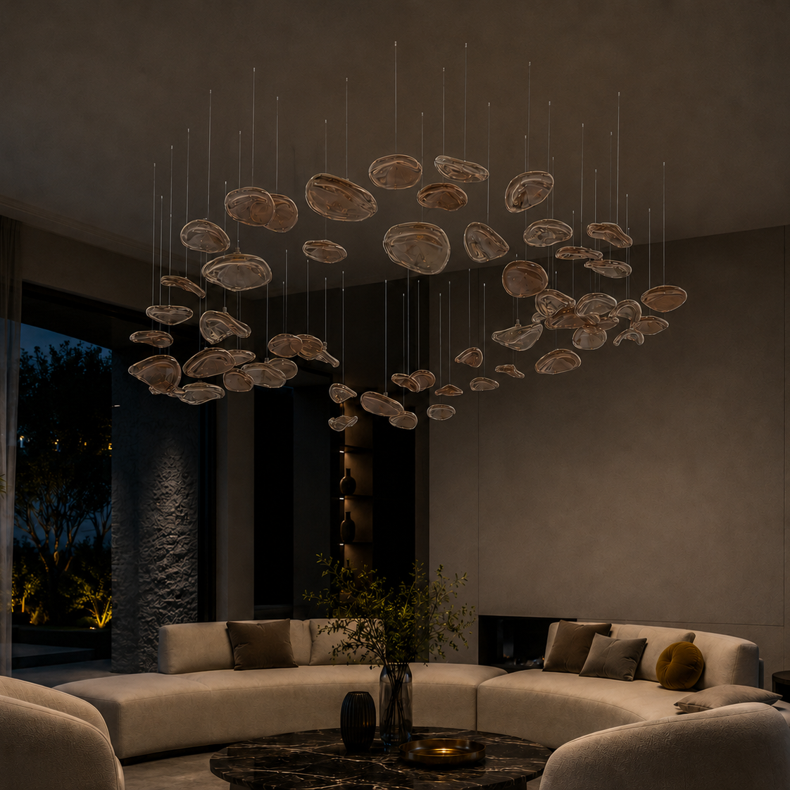 The Halo Chandelier by The Qratist features suspended rose gold glass elements arranged in a sculptural circular composition inspired by a radiant halo.